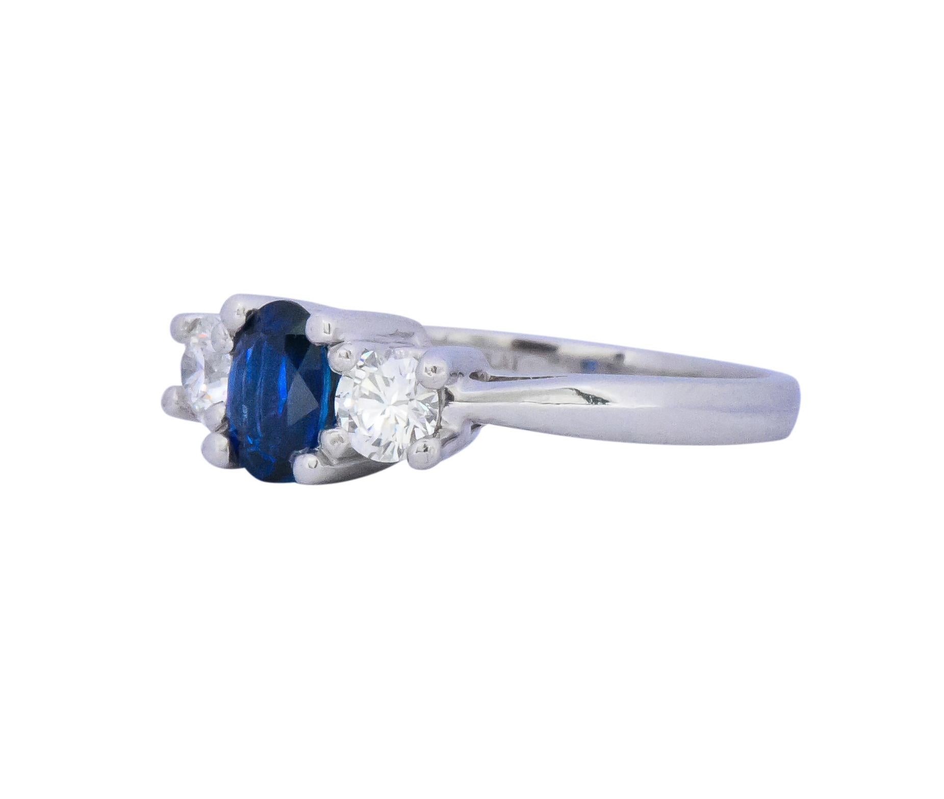 Centering an oval cut natural sapphire weighing approximately 0.70 carat, bright royal blue

Flanked on both sides by round brilliant cut diamonds, weighing approximately 0.45 carat total, G/H color and VS clarity

Fully signed Cartier and