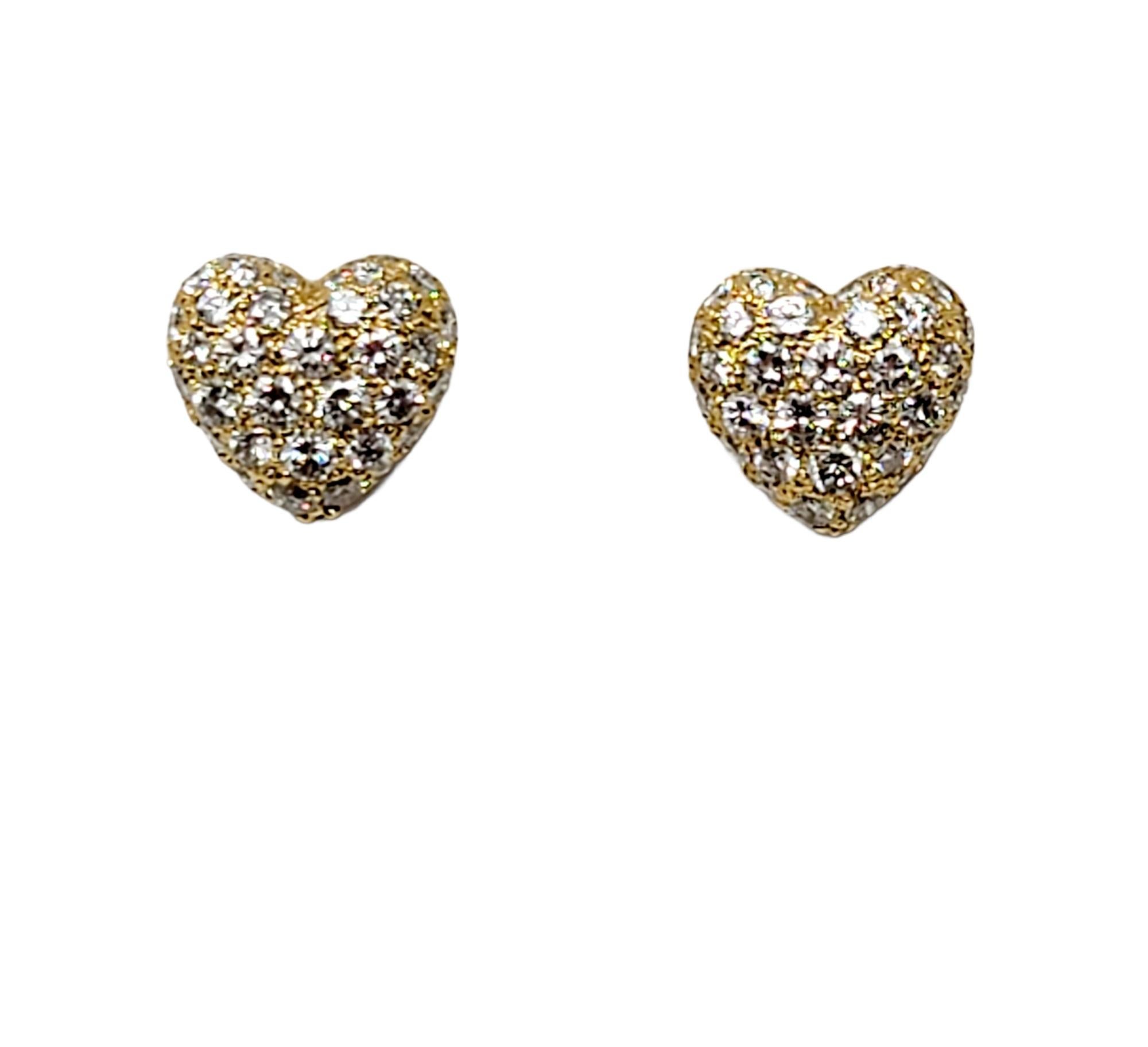 Stunningly sparkly pave diamond heart earrings from Cartier. These romantic and feminine earrings are bursting with glittering diamonds, really filling the lobe with icy white brilliance. They feature 72 shimmering round brilliant pave diamonds, F-G