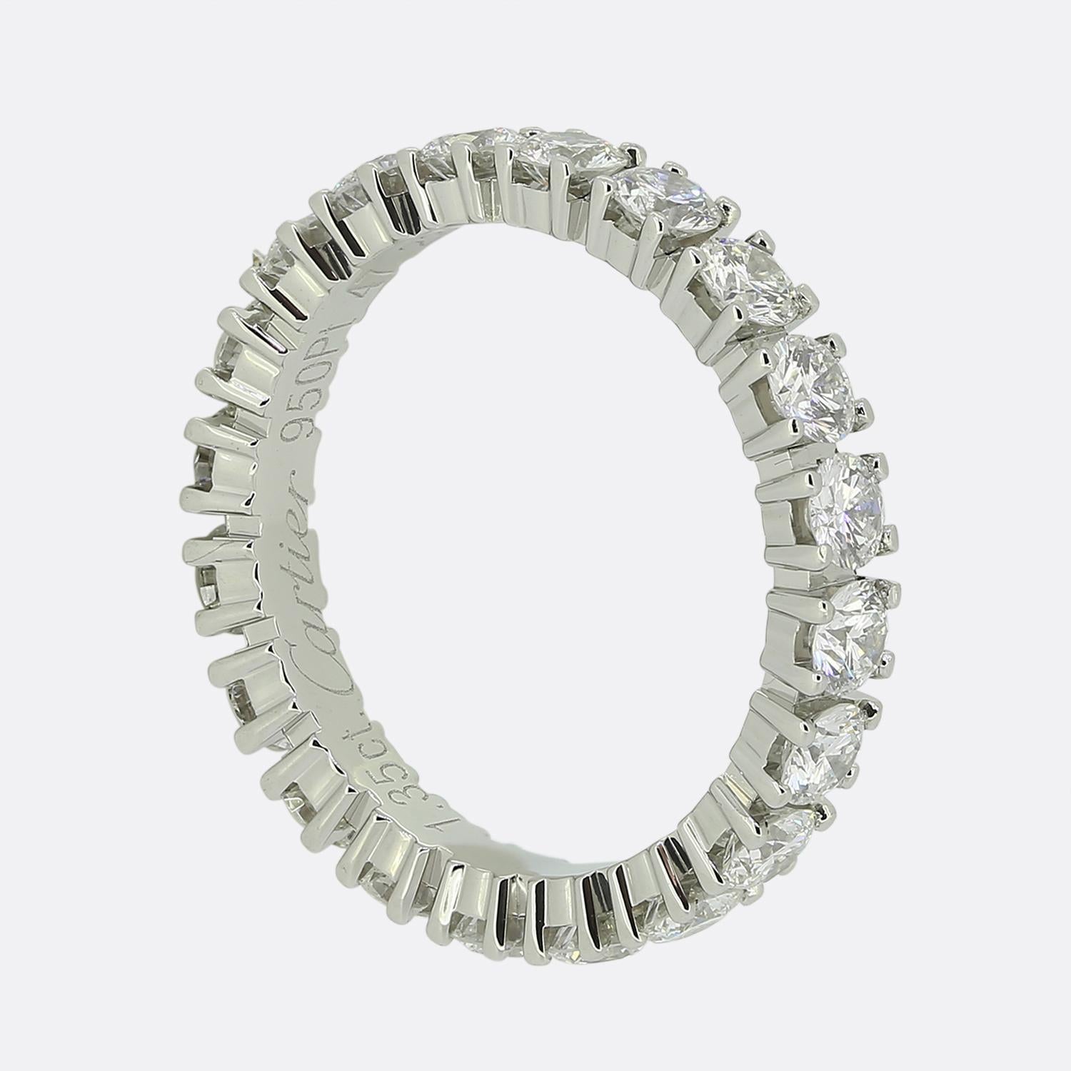 Here we have a platinum diamond eternity ring from the world renowned luxury jewellery house of Cartier. The band is adorned with a continuous row of bright white round brilliant-cut diamonds, each of which is perfectly matched and meticulously claw