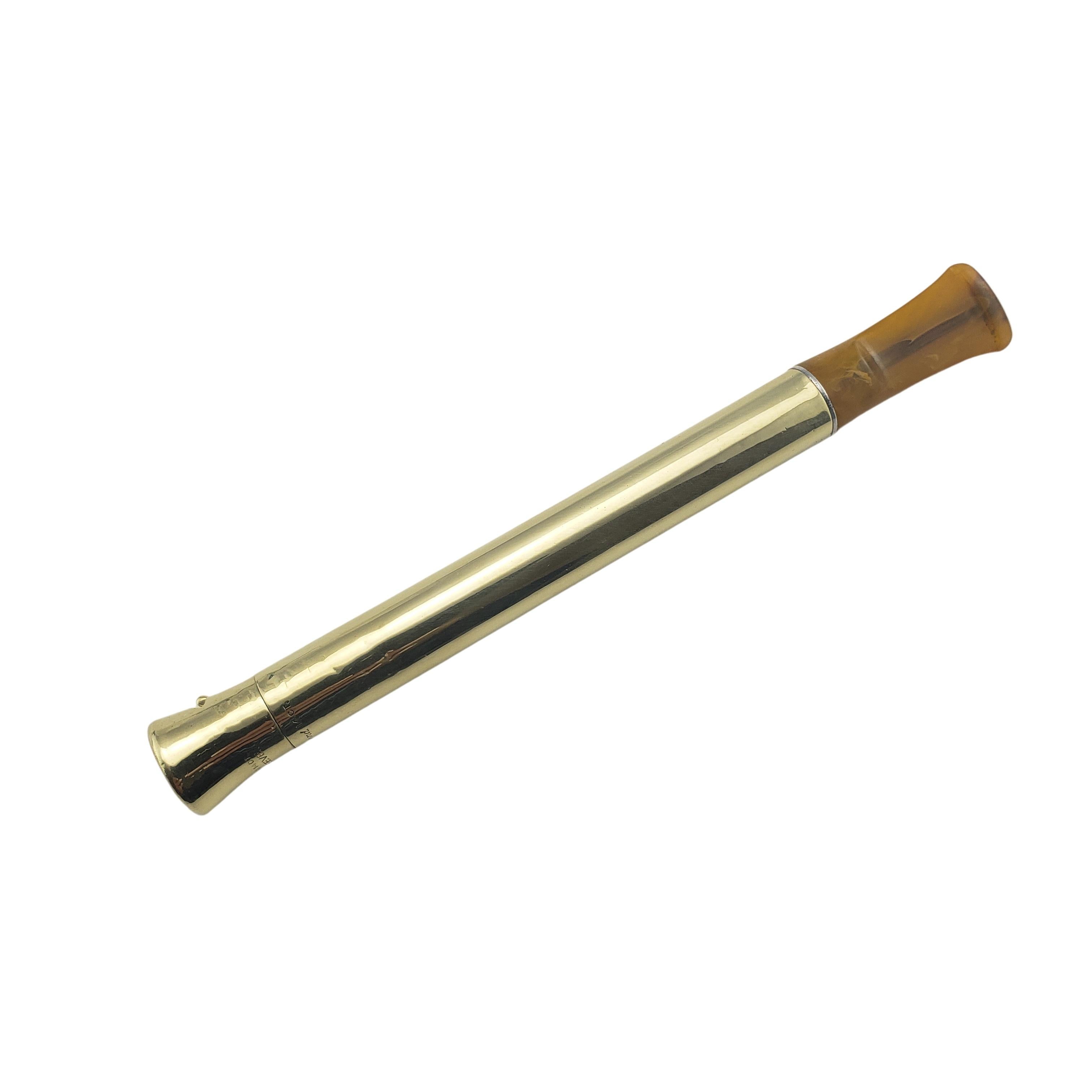 Vintage Cartier 14 Karat Yellow Gold Zeus Cigarette Holder-

This elegant piece by Cartier is crafted in meticulously detailed 14K yellow gold. Width: 10 mm. Amber mouthpiece.
Monogram reads 