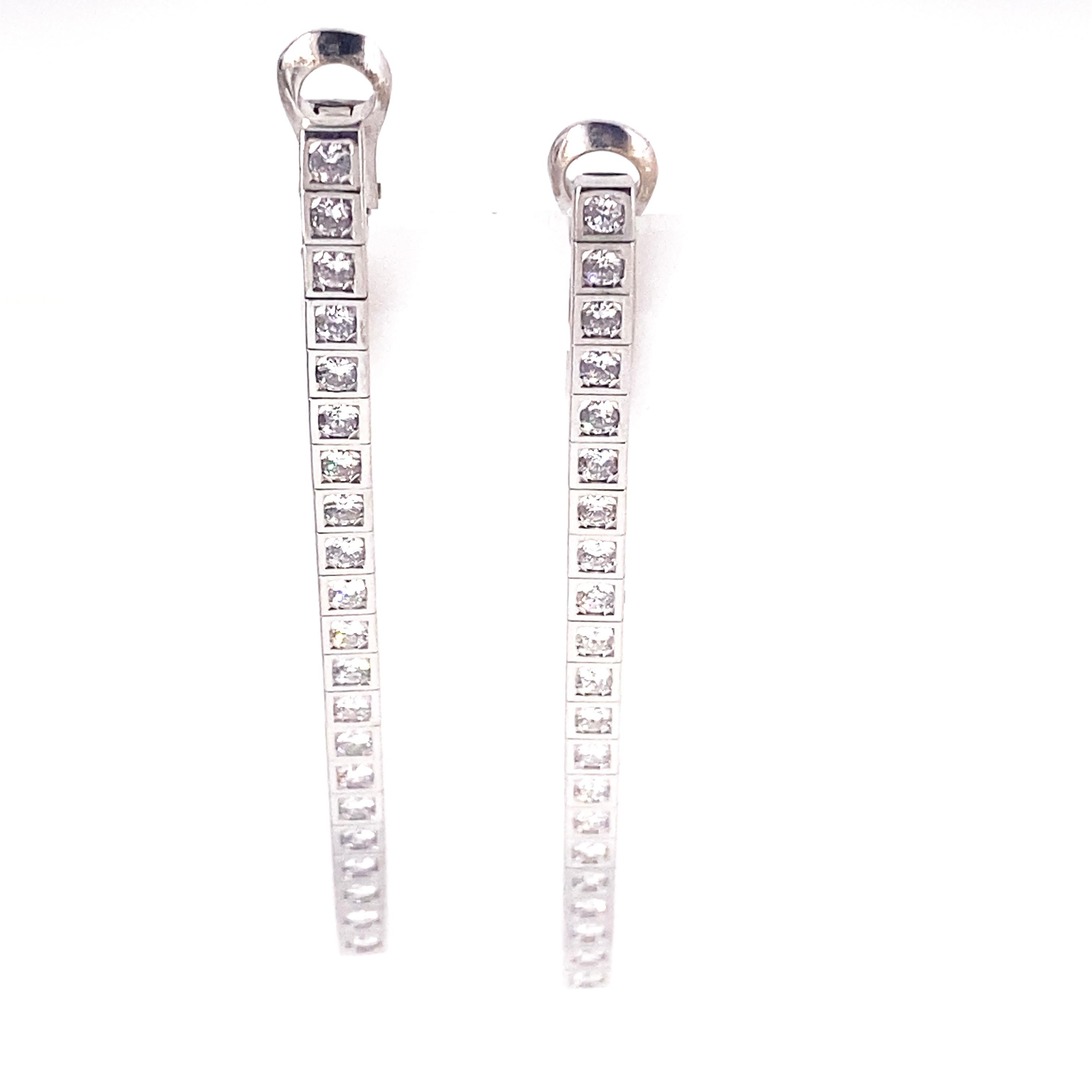 These beautiful Cartier drop earrings feature a total of 42 round diamonds with a total weight of 1.4 carats set in 14 Karat White Gold. These are of D/E color  VS+ quality. The length is approximately 6 cm.
Weight: 14 grams 