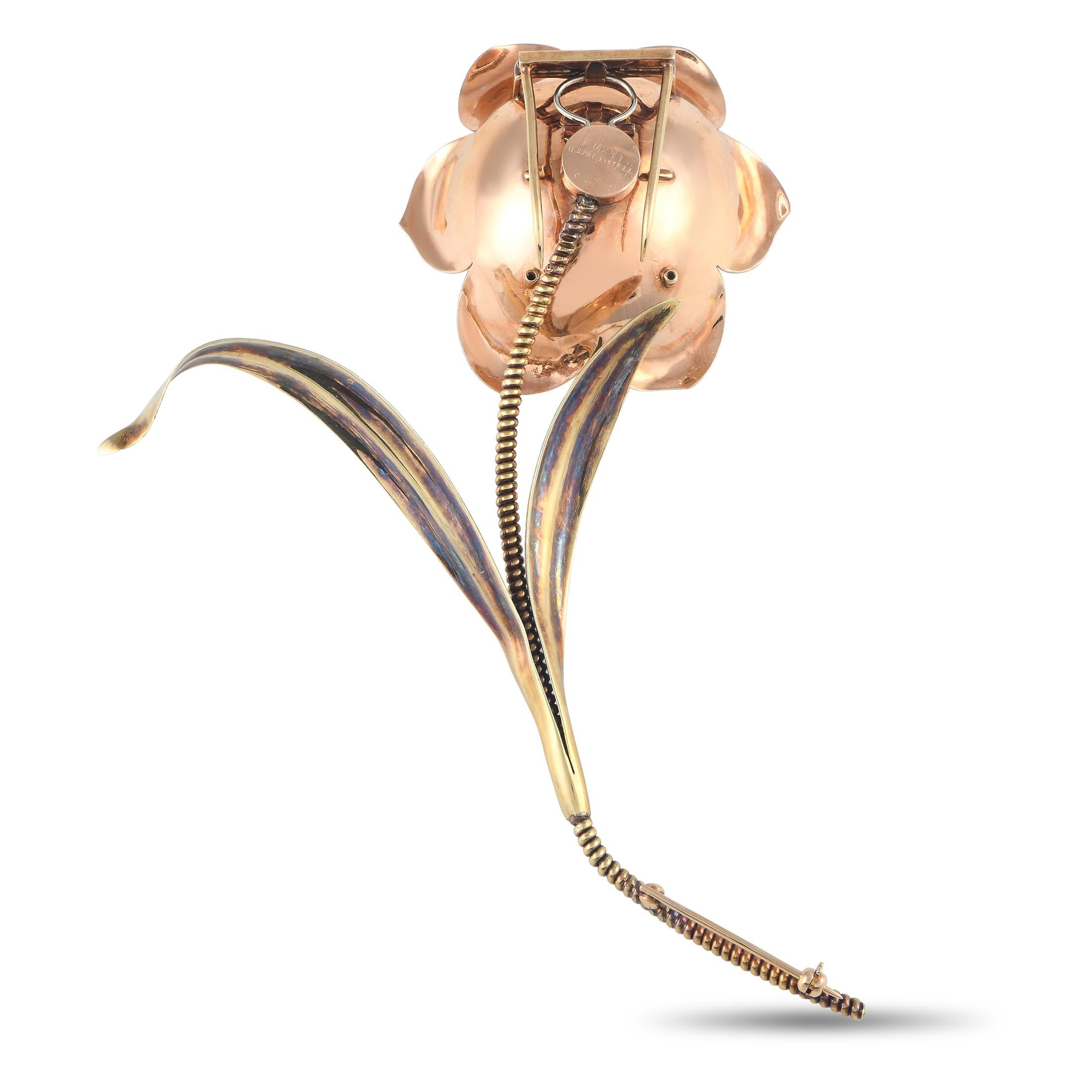 A blooming jewel to elevate your collection. This two-tone Cartier 'en tremblant' flower brooch features a rose gold blossom with a citrine cabochon on four prongs, punctuated by a trio of diamonds. The captivating bloom is held by an unusual