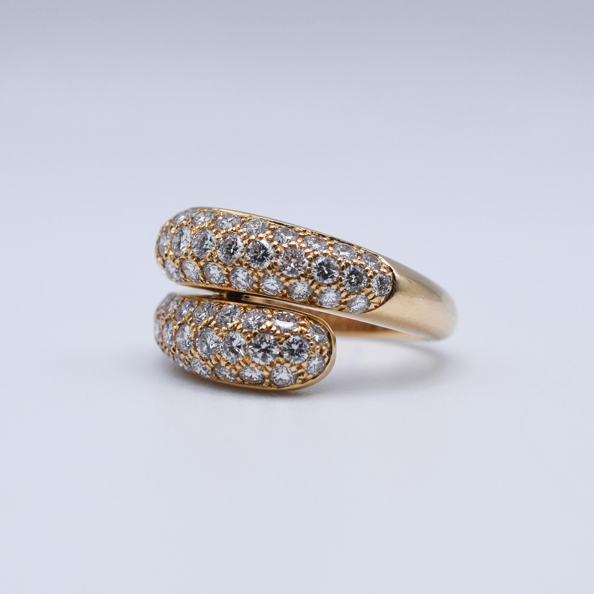 An elegant Cartier Diamond Bypass Ring, showcasing 1.50ct of pavé-set brilliant cut diamonds mounted on 18k yellow gold. Made in Paris, circa 1990.

Ring size: US 6.25