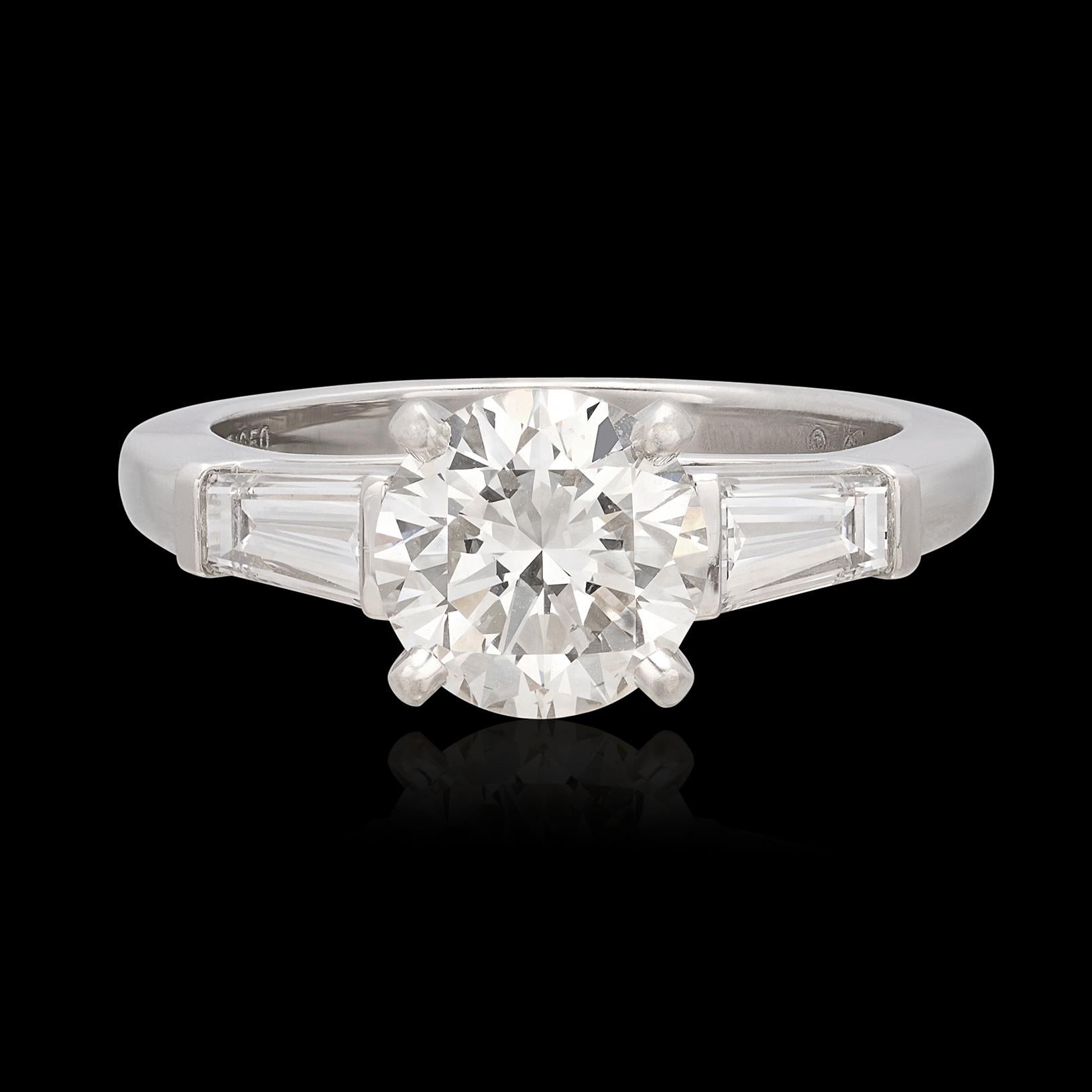 Look no further. Brilliant and sparkling, this Cartier platinum engagement ring may just be the perfect engagement ring. Featuring a round brilliant-cut diamond weighing 1.51 carats, GIA graded H/VS1, flanked by two tapered baguette-cut diamonds,