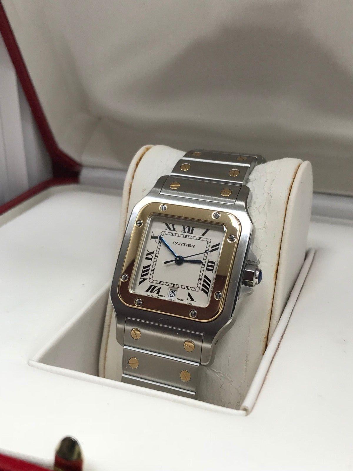 Style Number: 1566

Year: 2001

Model: Santos 

Case Material: Stainless Steel 

Band: Stainless Steel 

Bezel: 18K Yellow Gold

Dial: Ivory / White

Face: Sapphire Crystal 

Case Size: 29mm

Includes: 

-Cartier Box & Papers

-Certified Appraisal
