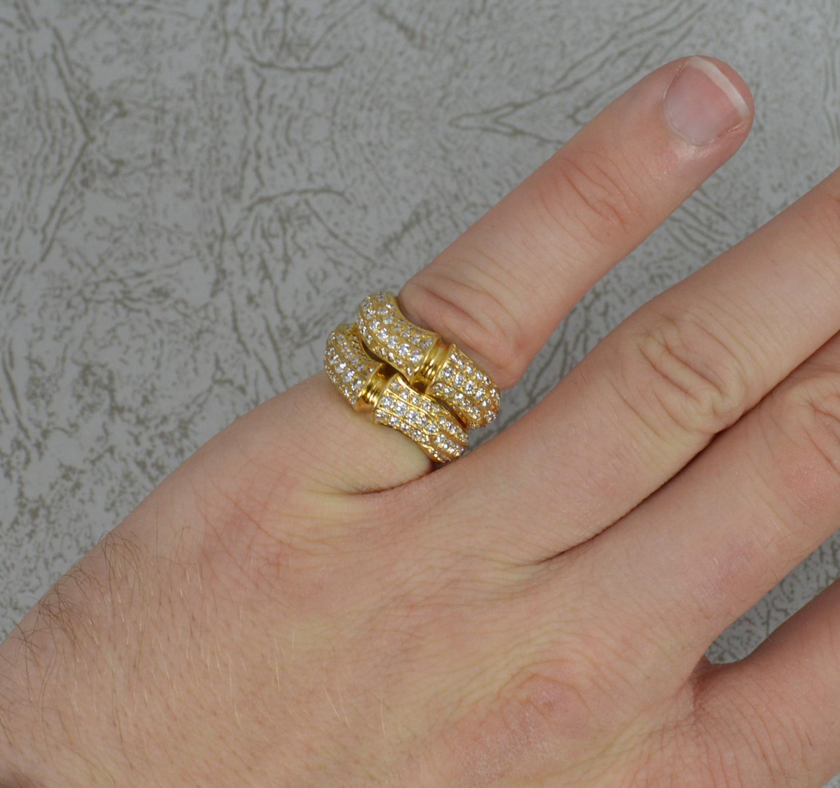 A stunning Cartier double bamboo cluster ring.
Weighty and solid 18 carat yellow gold example.
Set with many round brilliant cut, natural diamonds, totalling just over 1.50 carats. Vvs clarity, e-f colour.
21mm spread of stones. 12.9mm wide band to