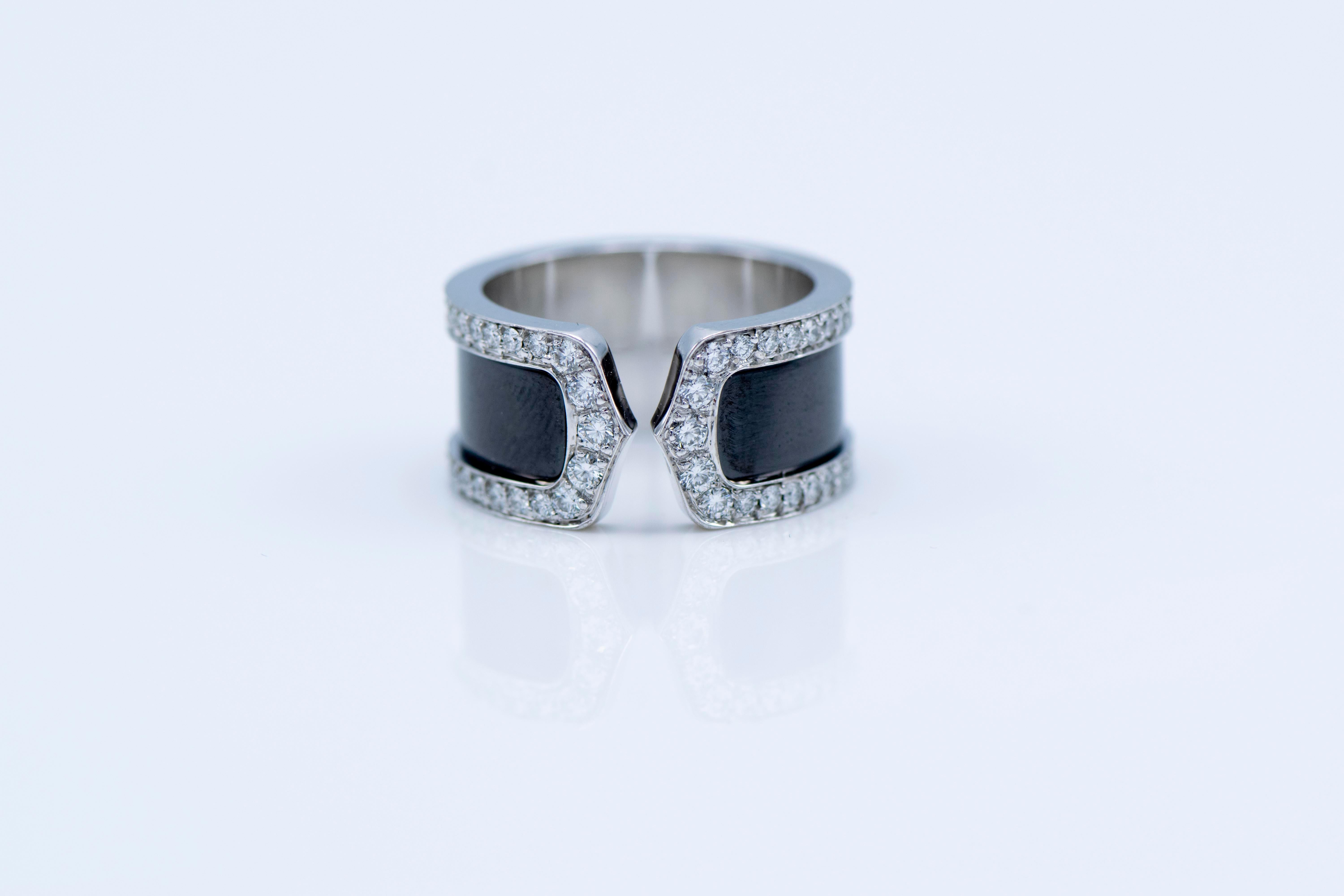 Cartier Diamond  open band “Double C” crafted in solid 18K white gold.It displays a double C open design with its band embellished with black finish enclosed within a frame of 76 genuine round cut Diamonds approx: 0.90cttw, E-F color, VVS clarity,