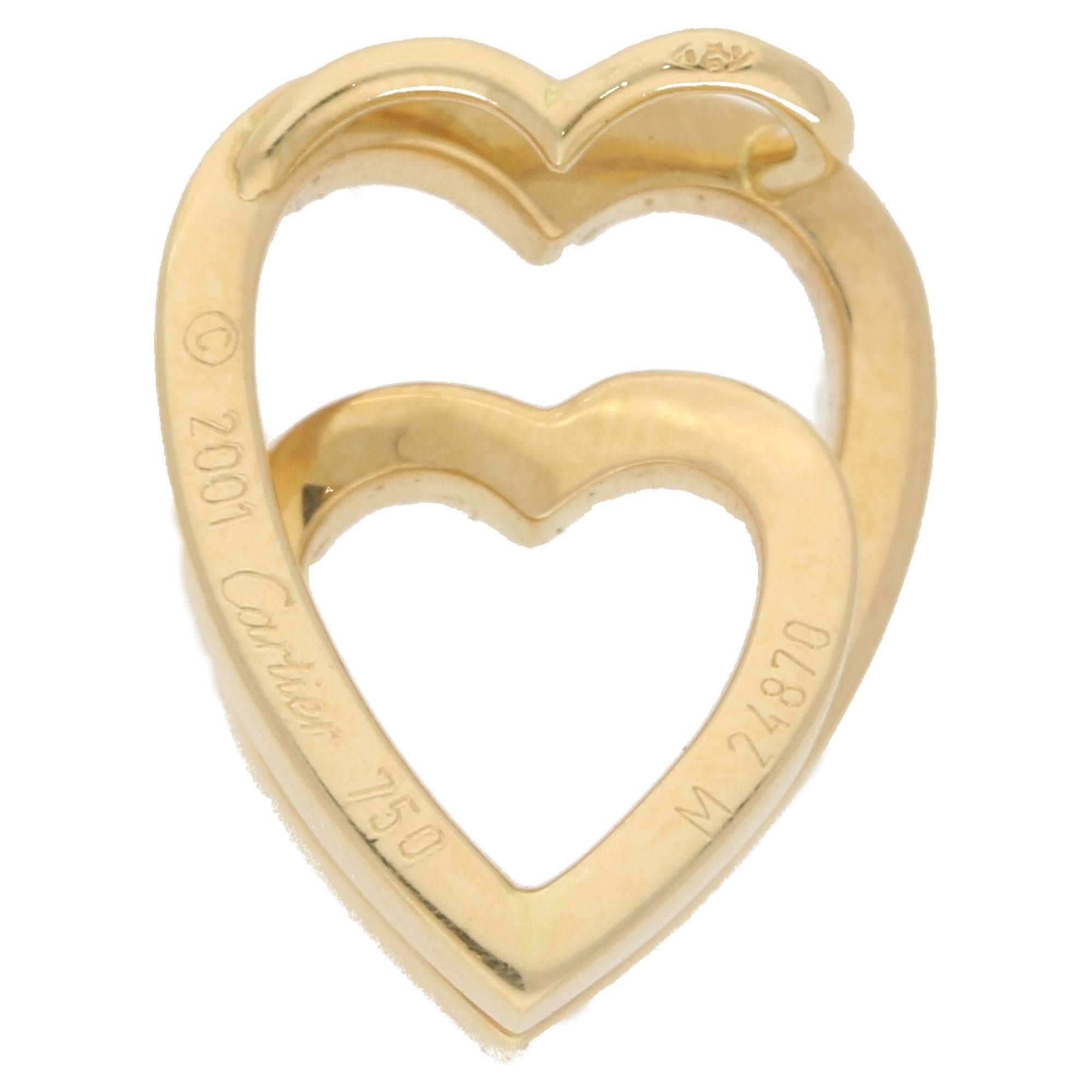  A Cartier 'Double Love' pendant featuring a heart cradling a second heart in 18ct yellow gold. The pendant measures 18x15mm.