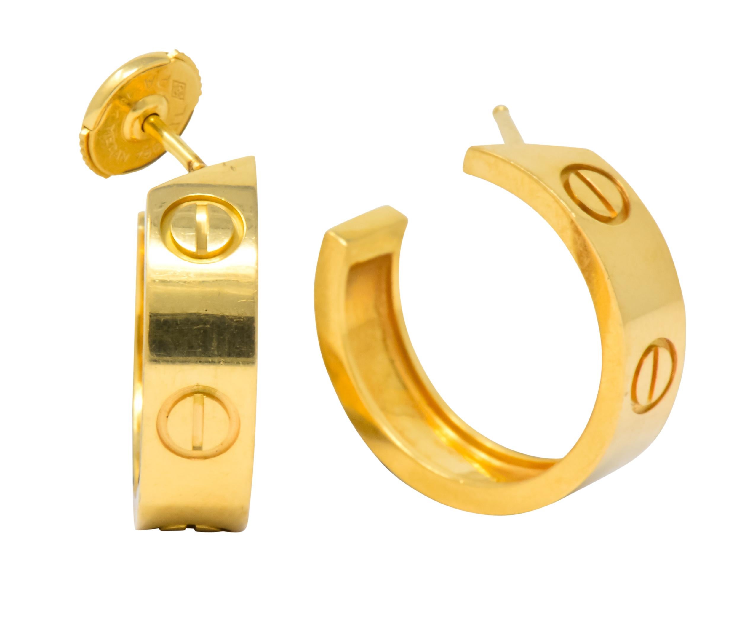 Designed as hoops with posts and stamped screw head detail

La pousette backs 

From the coveted Cartier Love collection

Fully signed and numbered, stamped 750

Measures: 4 1/2 x 1/4 (width) inches

Inner Diameter: 3/4 inch

Crisp. Classic.