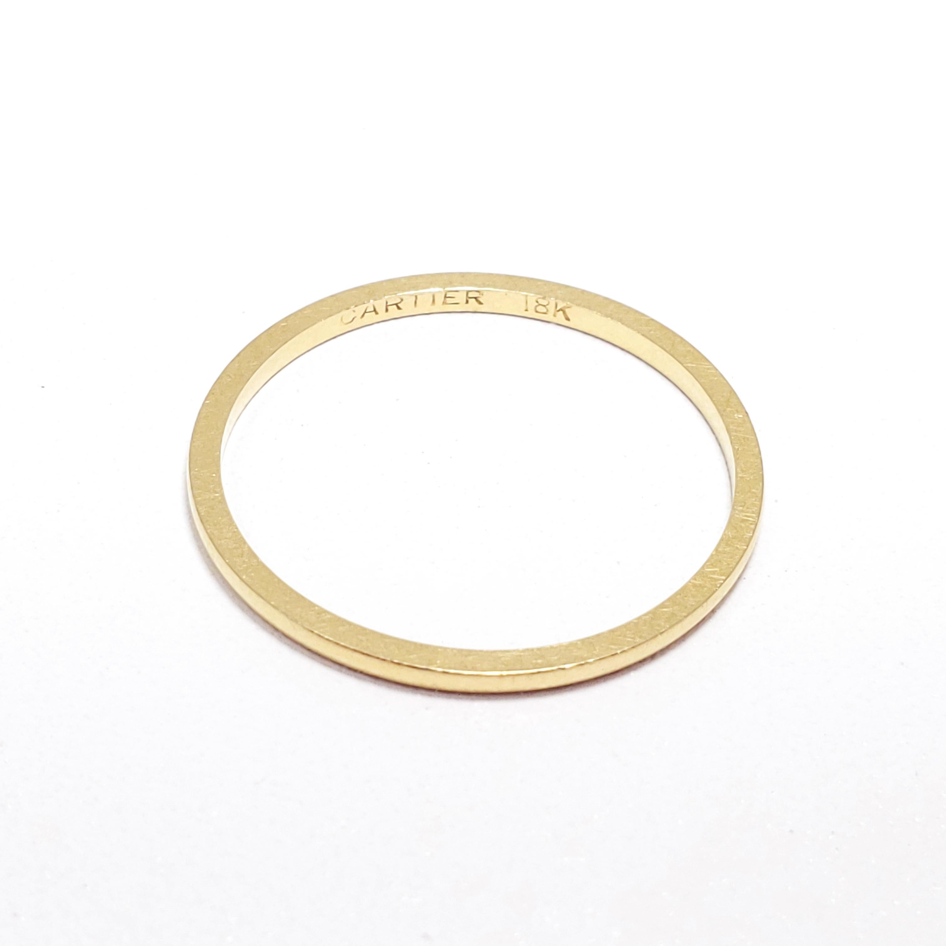 A vintage, 18K gold band from Cartier. Stylish minimalist design with the excellent Cartier-standard quality. Excellent as a fashion accessory and wedding band.

US size 11.5
Ring height/thickness: 1.37 mm
Hallmarks: CARTIER, 18K
Weight: 1.7
