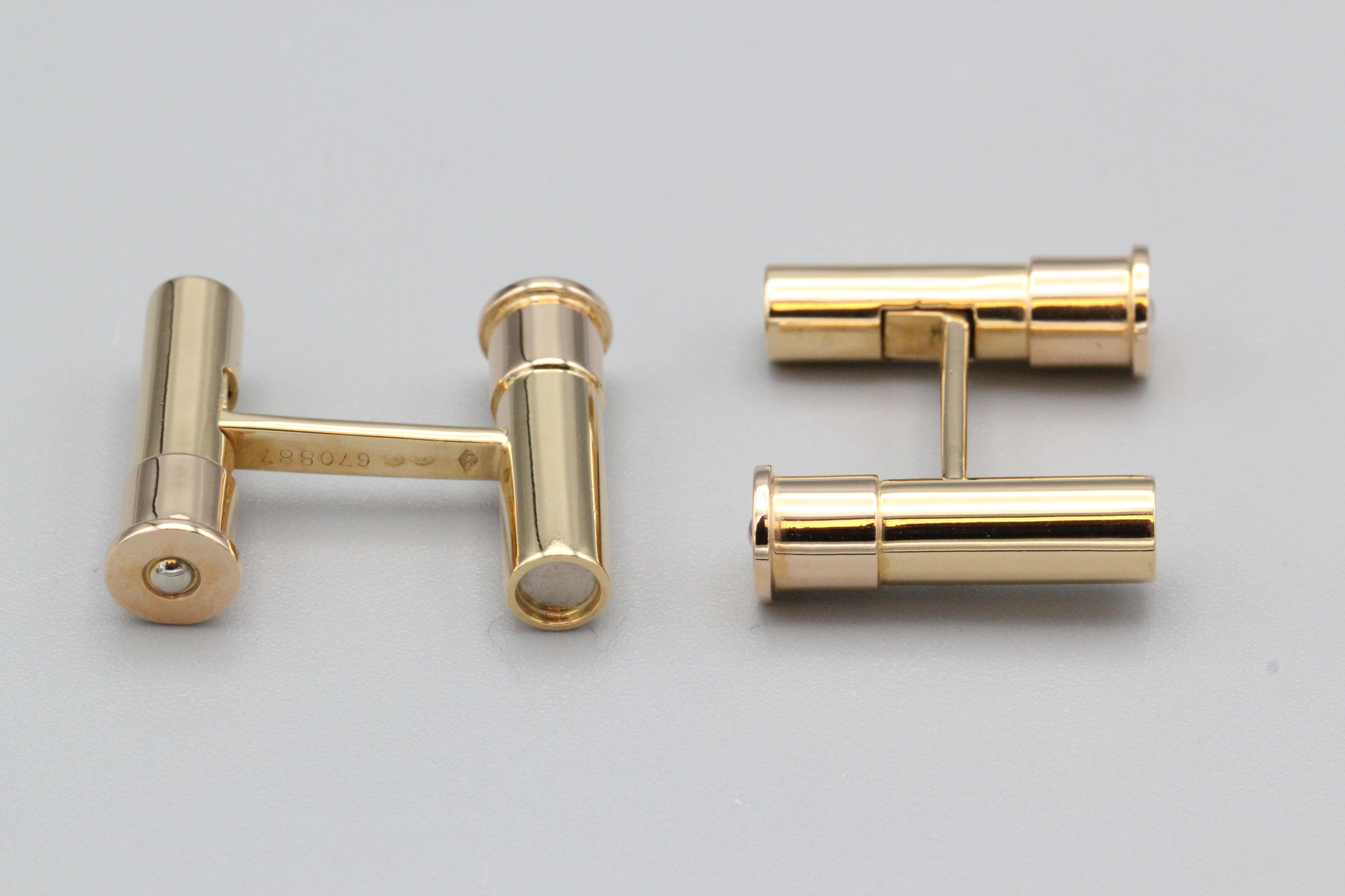 Fine pair of 18K gold bar cufflinks by Cartier.  These cufflinks feature a bar design with each bar designed as a shotgun shell.  Of very fine quality and handsome style.

Hallmarks: Cartier,  reference numbers, 18k gold assay marks, 750, maker's