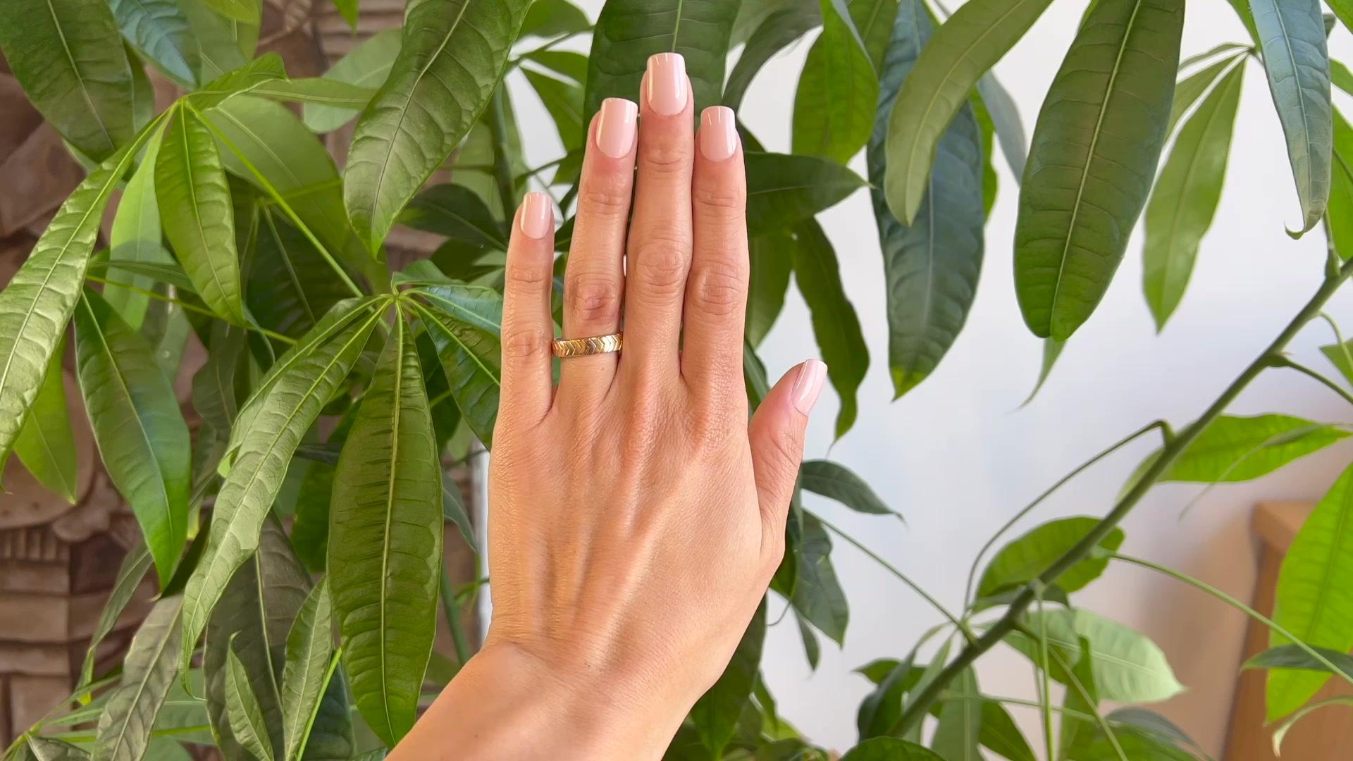 One Cartier 18 Karat Gold Tricolor Chevron Band Ring. Crafted in 18K yellow, rose, and white gold signed Cartier, serial #557200 with hallmarks. Circa 2010. The ring is a size 9 1/2.

About this Item: Everyone needs a sleek Cartier Ring in their