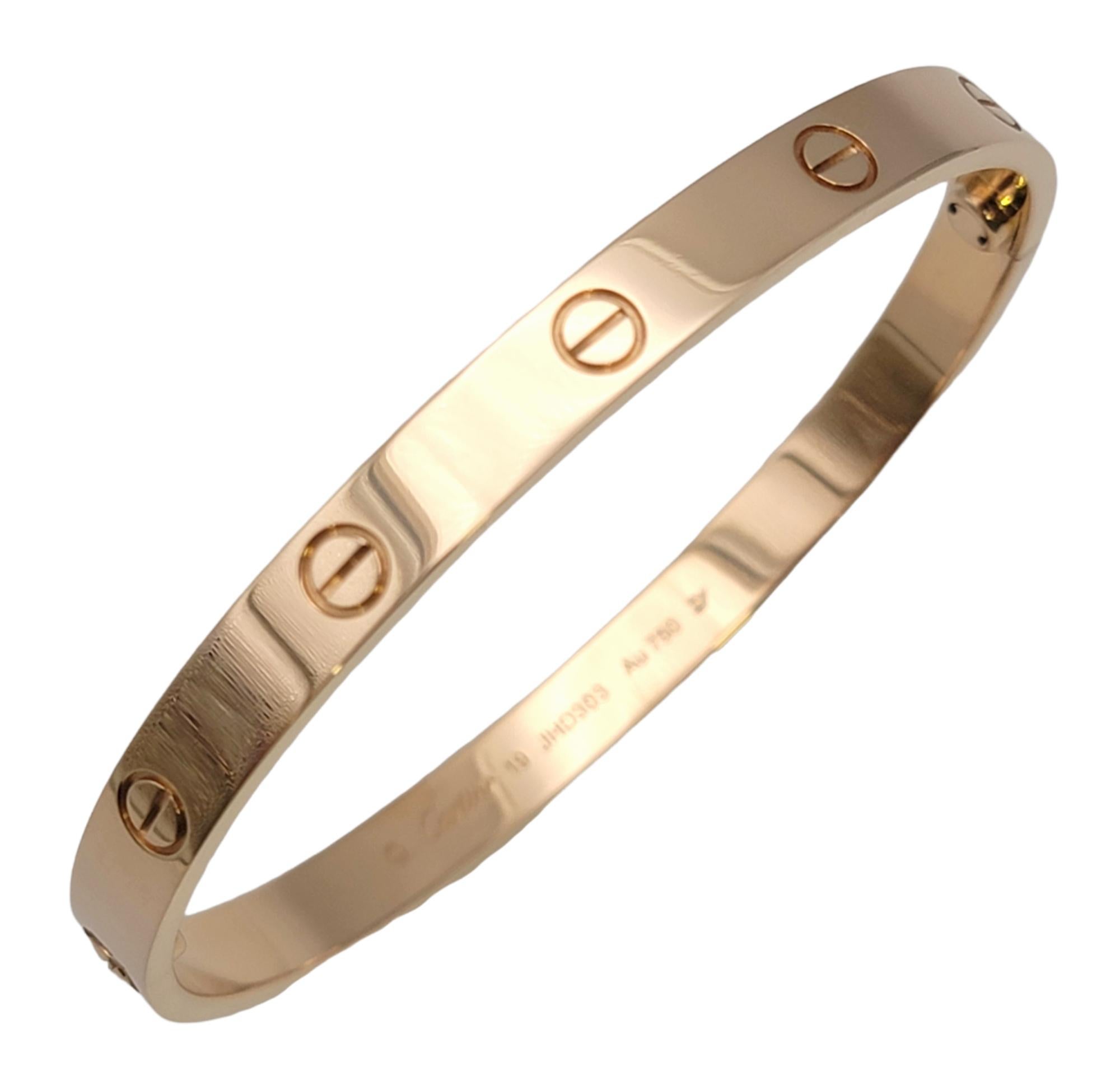 Iconic Love bangle bracelet from luxury jeweler, Cartier. This simple, yet effortlessly timeless piece makes a chic statement on the wrist. With its clean lines, perfect symmetry, and flawless elegance, this bracelet will remain one of your jewelry