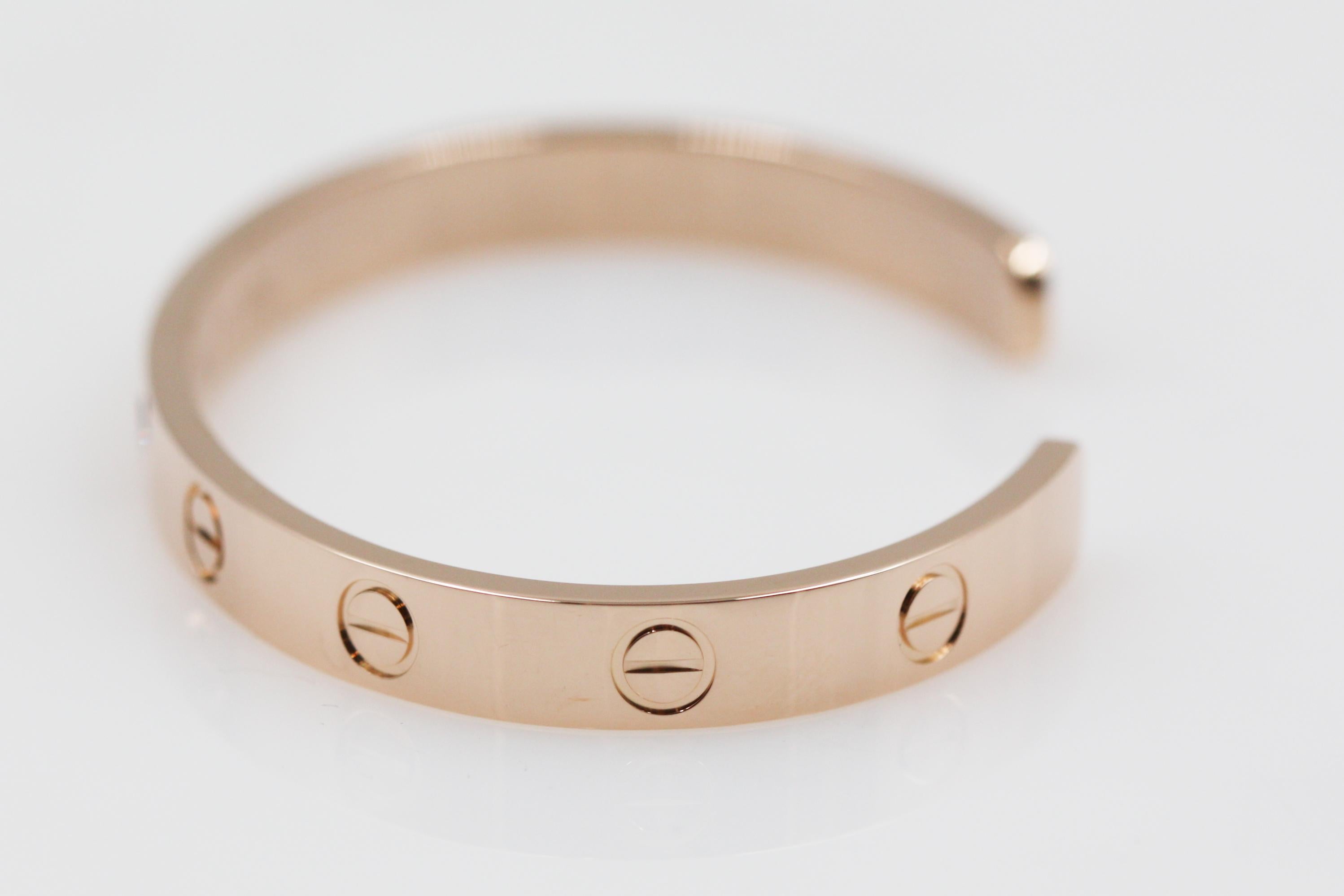 A beautiful cuff bracelet from Cartier Love collection, made in 18K rose gold. The bracelet have the iconic screw motif and set with 1 pink sapphire stone. 

Size: 16
We have other size available, please feel free to ask.

Item comes with an