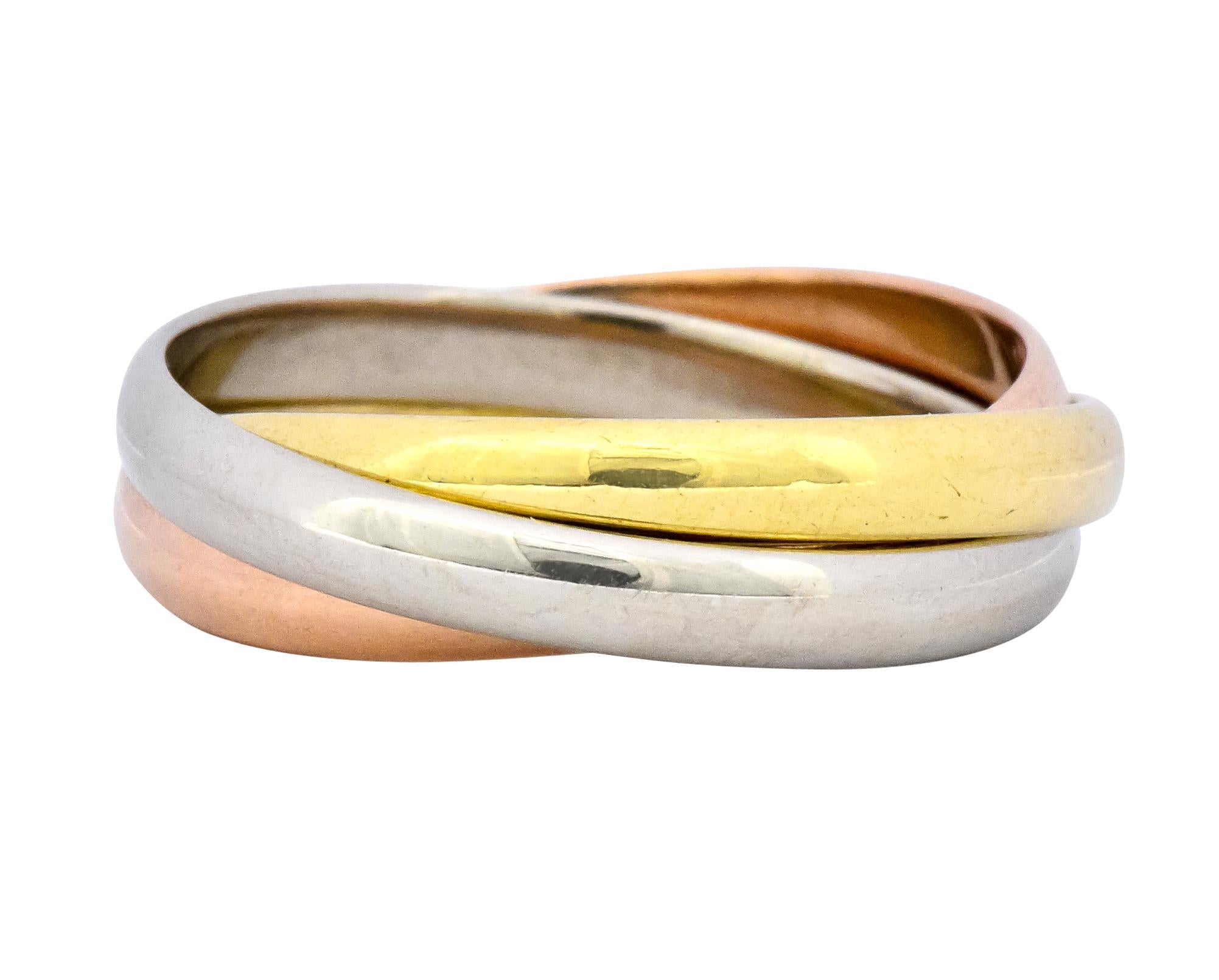 Featuring three intersecting white, yellow, and rose gold band rings with a high polished finish

Fully signed Cartier and stamped 18k for 18 karat gold

Ring Size: 8 & not sizable

Top measures: 2.5 mm and sits 1.0 mm high

Total weight: 6.4