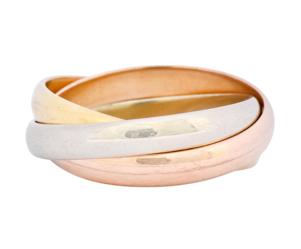 Featuring three intersecting white, yellow, and rose gold band rings with a high polished finish

Fully signed Cartier and stamped 18k for 18 karat gold

Ring Size: 3 & not sizable

Top measures: 4.9 mm and sits 2.0 mm high

Total weight: 4.0