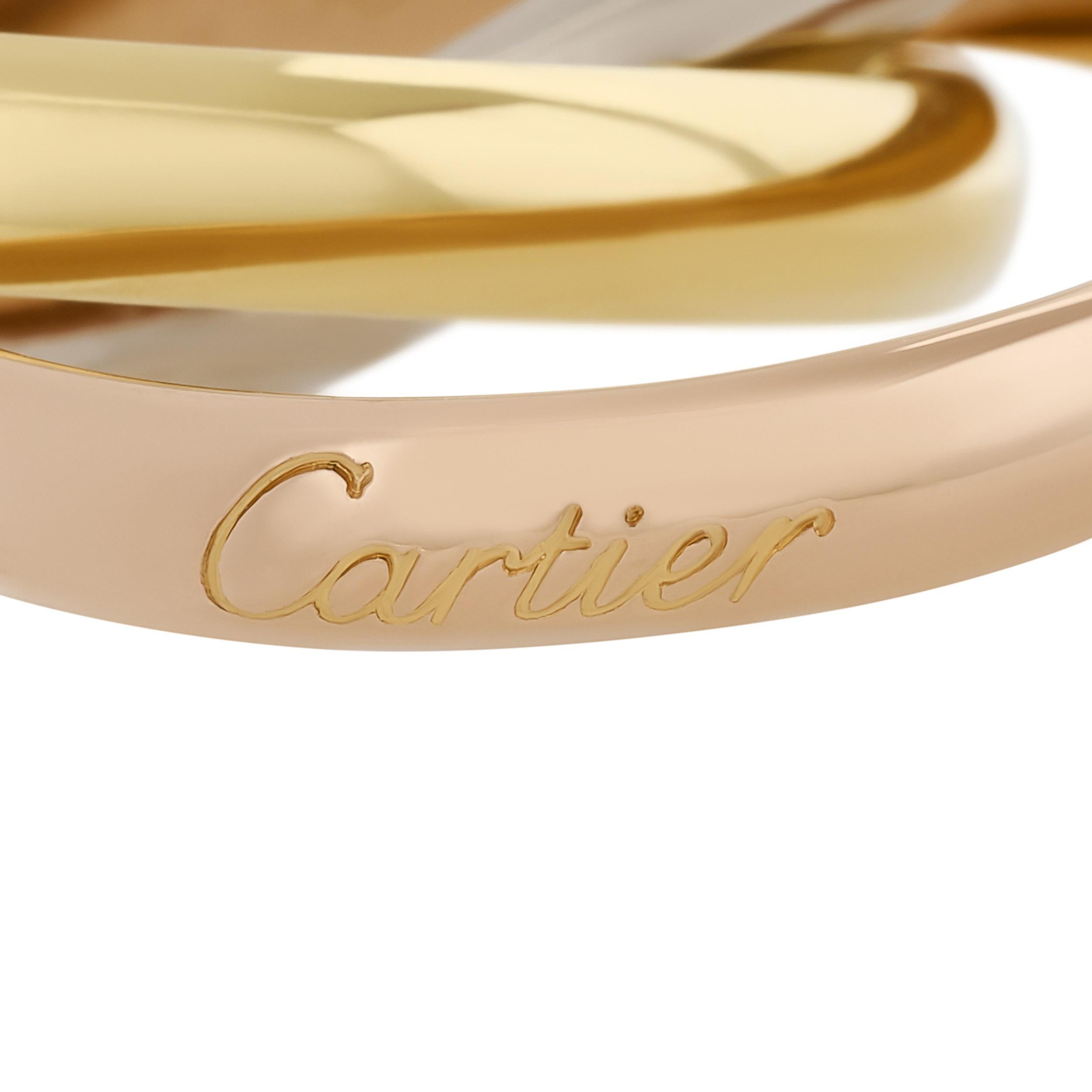 A timeless trio: this Cartier tri-color gold rolling band ring intertwines yellow, white, and rose gold, symbolizing love, fidelity, and friendship.

Size 60 (US 9)
Numbered and signed Cartier.
