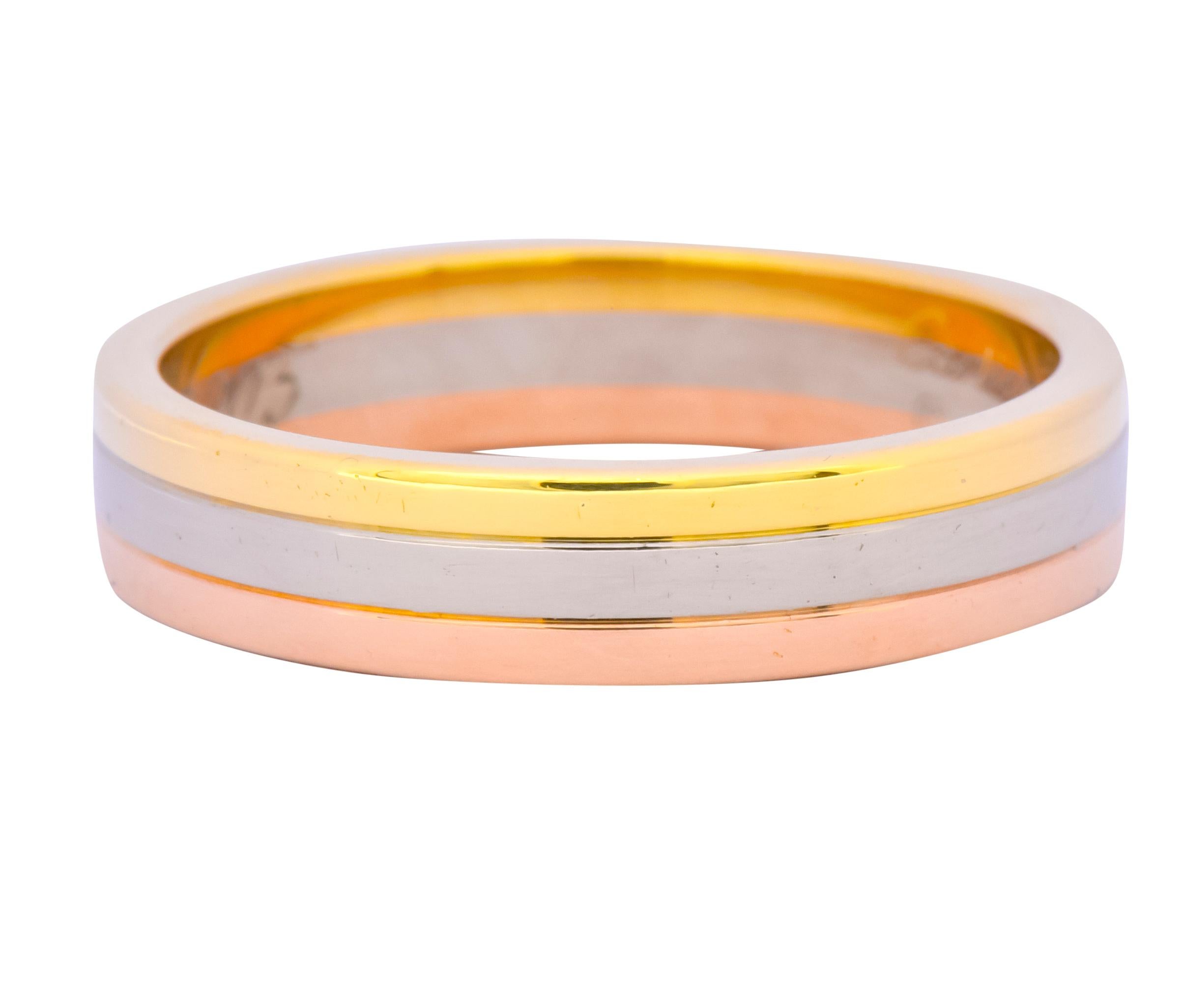 Wide band style ring comprised of three horizontal sections of yellow, white, and rose gold

With a high polished finish

Inner band with dated inscription

From Cartier's contemporary Trinity collection

Fully signed Cartier and numbered

Stamped