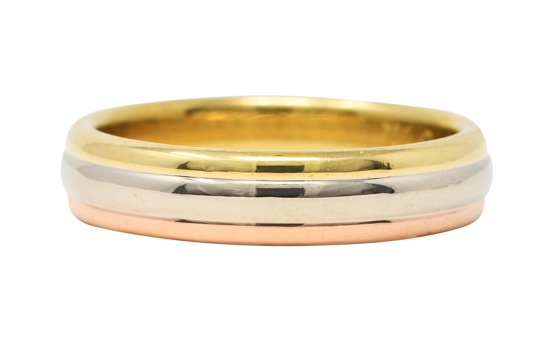 Band style ring comprised of three horizontal sections of yellow, white, and rose gold

With a high polished finish and rounded curvature for each section

Stamped 1998 and from the Trinity collection

Fully signed Cartier and numbered

Stamped 750