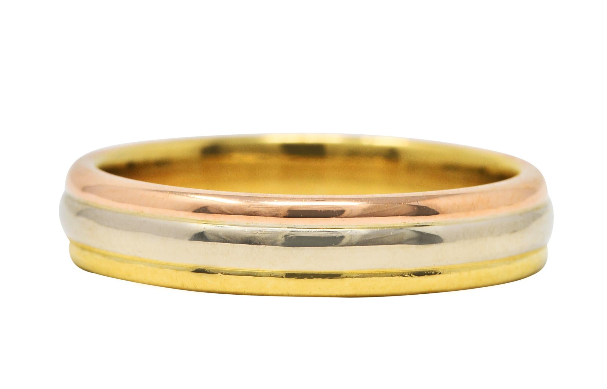 Band style ring comprised of three horizontal sections of yellow, white, and rose gold

With a high polished finish and rounded curvature for each section

Stamped 1996 and from the Trinity collection

Fully signed Cartier and numbered

Stamped 750