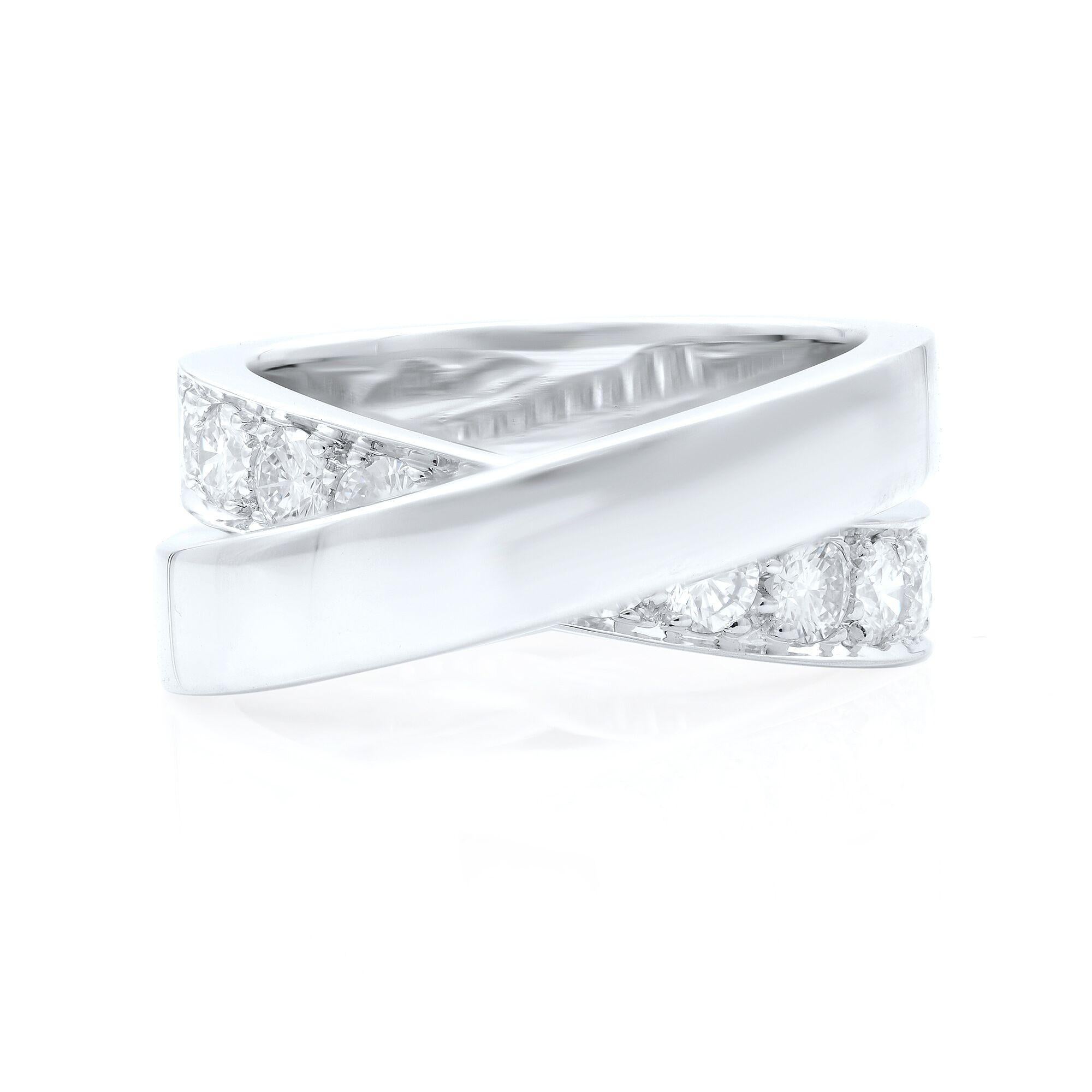 A sleek and classic criss- cross design ring from Cartier. It is sparked with 1.00 cts. of round brilliant-cut diamonds. Set in polished 18kt white gold. Hallmarked, Cartier 750 1999 53 and serial number. Ring size 6.5. Width: 8.80-4.80 mm.