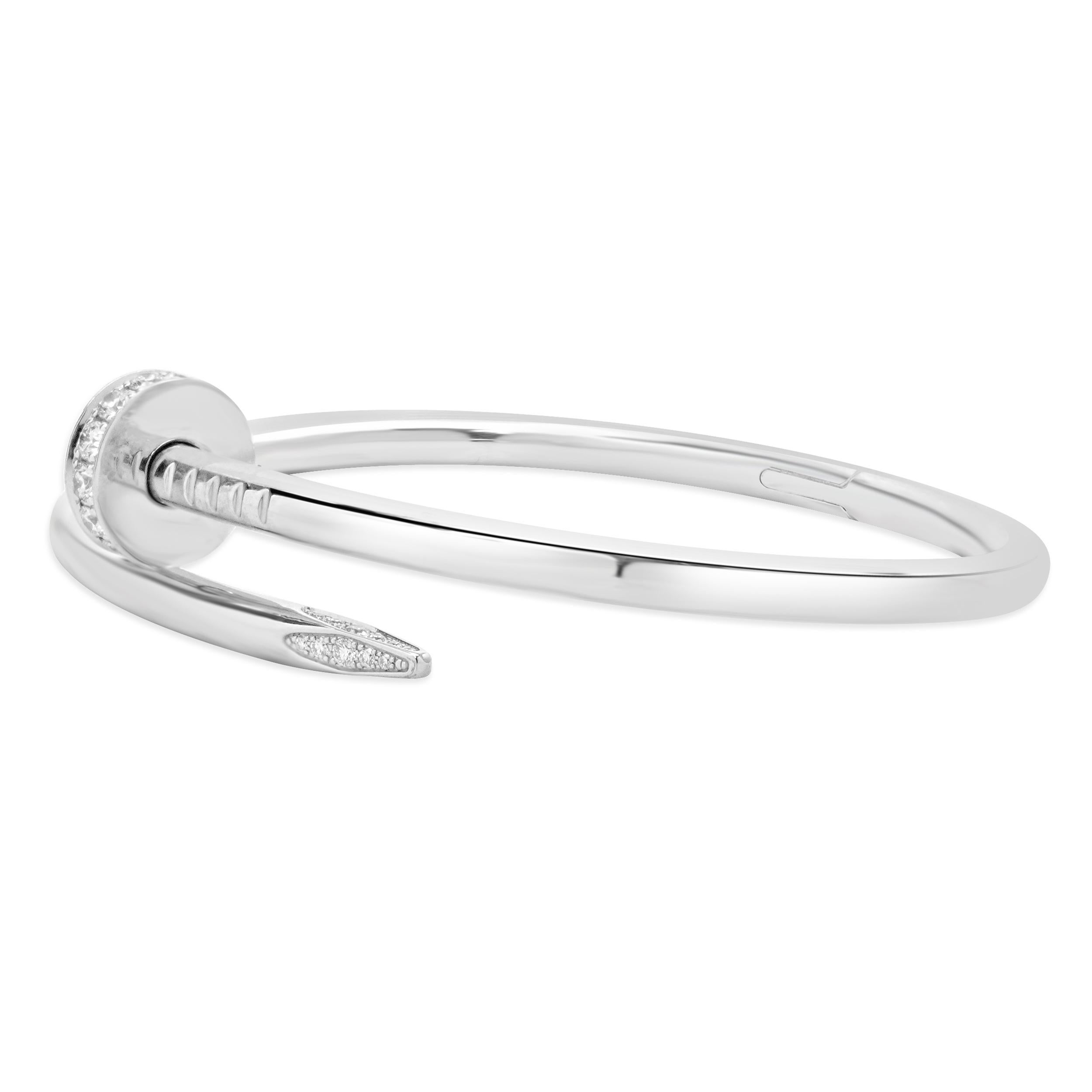 Designer: Cartier
Material: 18K white gold
Diamonds: 32 round brilliant cut = 0.58cttw
Color: F / G
Clarity: VS2
Serial # SNKXXX
Weight: 31.31 grams
Size: 16

Comes with papers, no box
