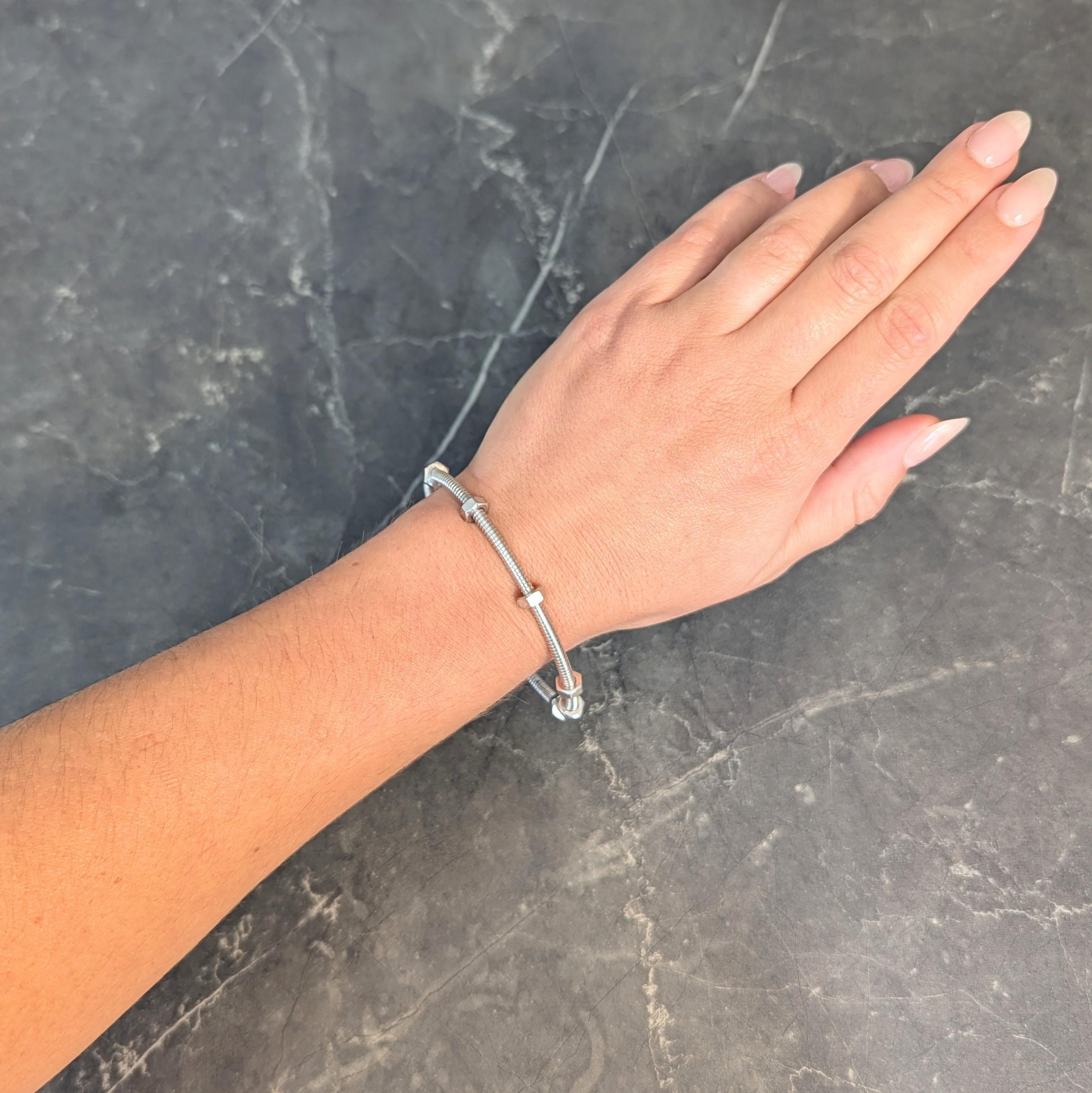 Designed as white gold cords bangle with screw-style threading
Accented by six hexagonal nut stations 
Position can be adjusted via twisting
Stamped for 18 karat gold
Numbered and fully signed with maker's mark for Cartier
Circa: 2000s; via the