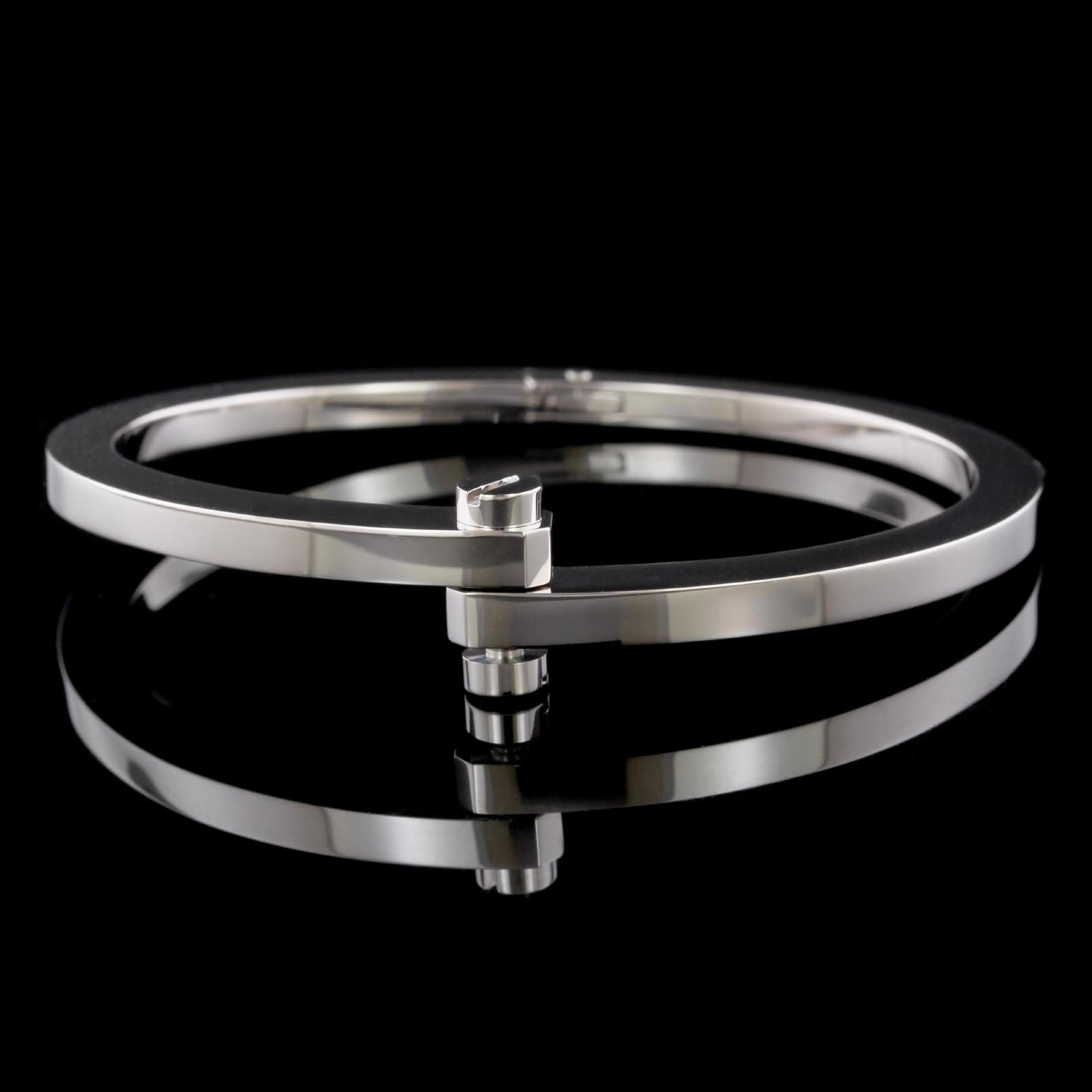 Cartier 18K White Gold Le Menotte Bracelet. The bracelet is designed with the signature screw closure, #BO7344, circa 2004, interior circumference 6 1/2