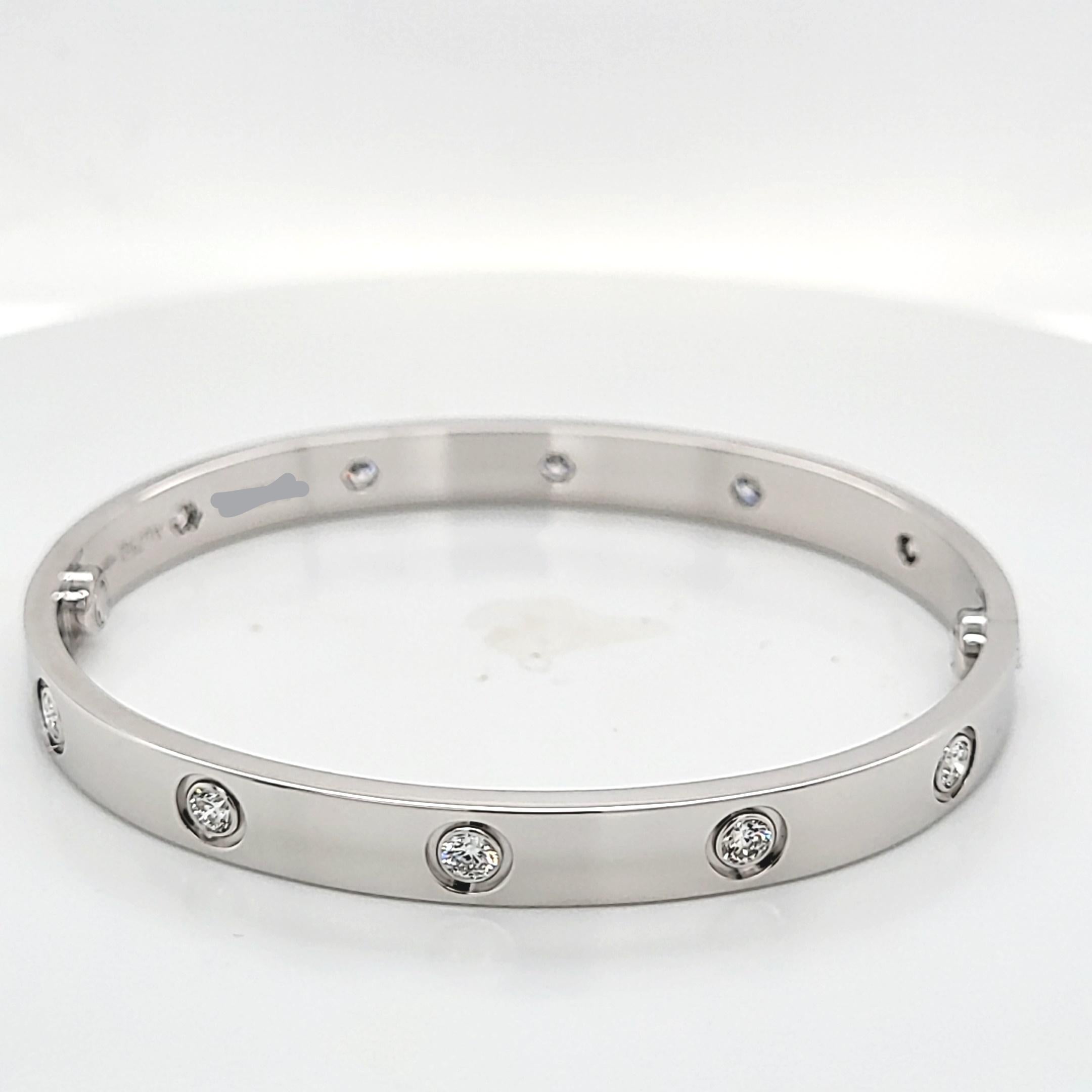This iconic bracelet from Cartier features 10 round diamonds with a total weight of 0.96 carats. It is crafted in 18 karat white gold and the width measures 6.1mm. It is a size 17. The screwdriver, certificate, and original box are included. The