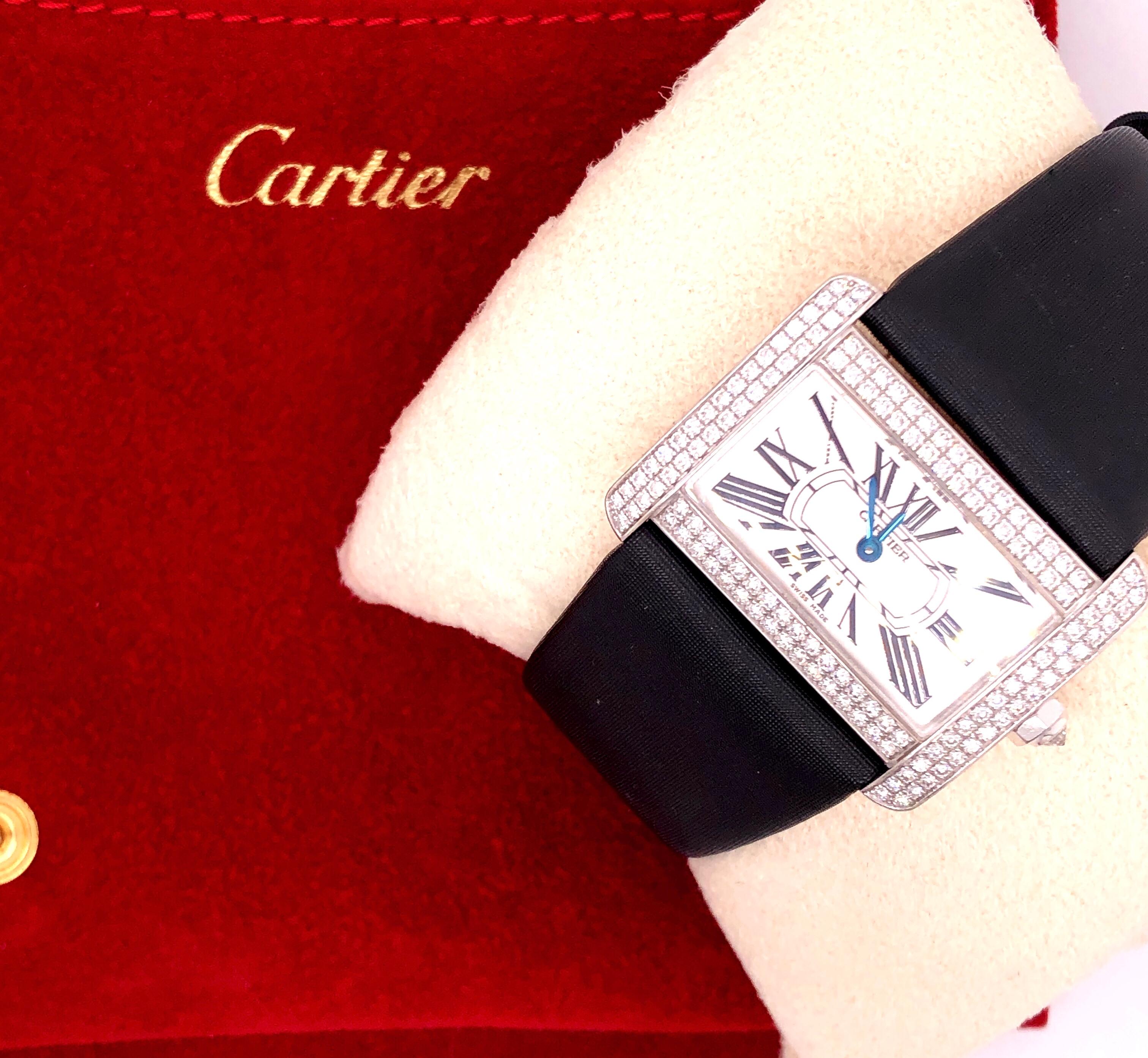 Cartier 18 Karat White Gold Mini Tank Divan Watch, Diamond Paved Case, Fabric Strap, 18 Karat Gold Diamond Paved Buckle, Quartz Movement.
153 X Round Brilliant Cut Diamond
1.36 ct. total diamond weight.
37.00 grams total weight.
Ref no.