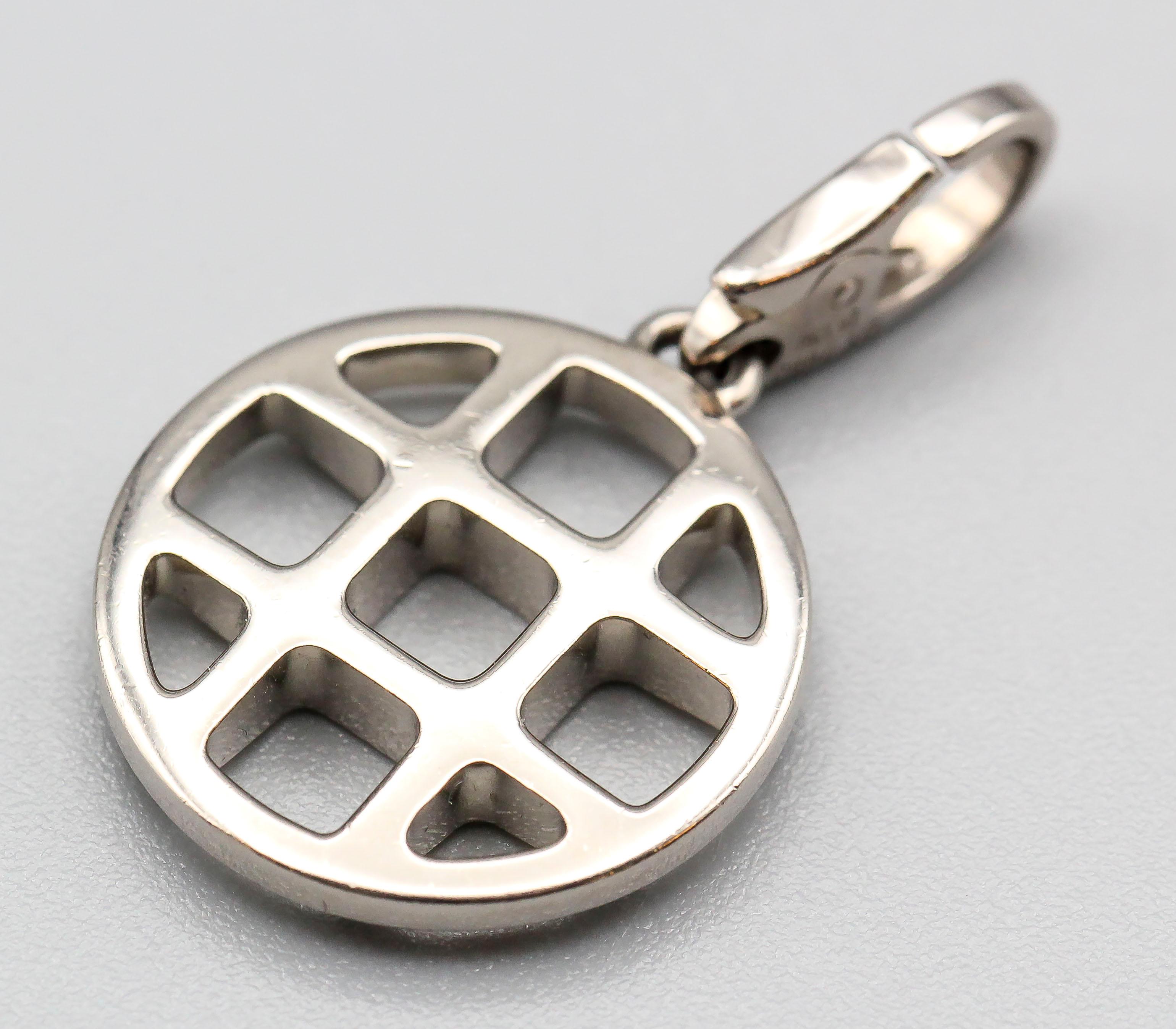 Fine 18K white gold charm by Cartier. It features the iconic Cartier Pasha grill.  Well made and easy to add to any bracelet or pendant.

Hallmarks: Cartier, 750 reference numbers