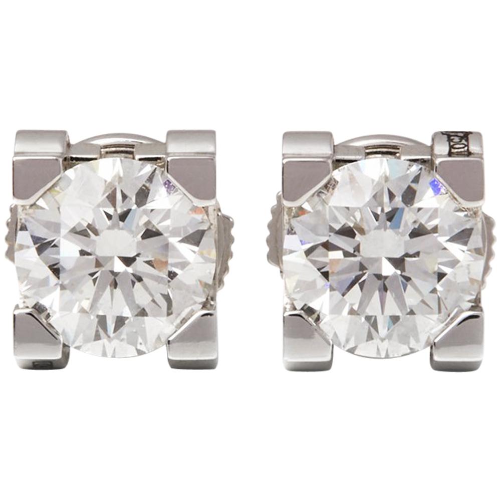 cartier diamond earrings with c on the side