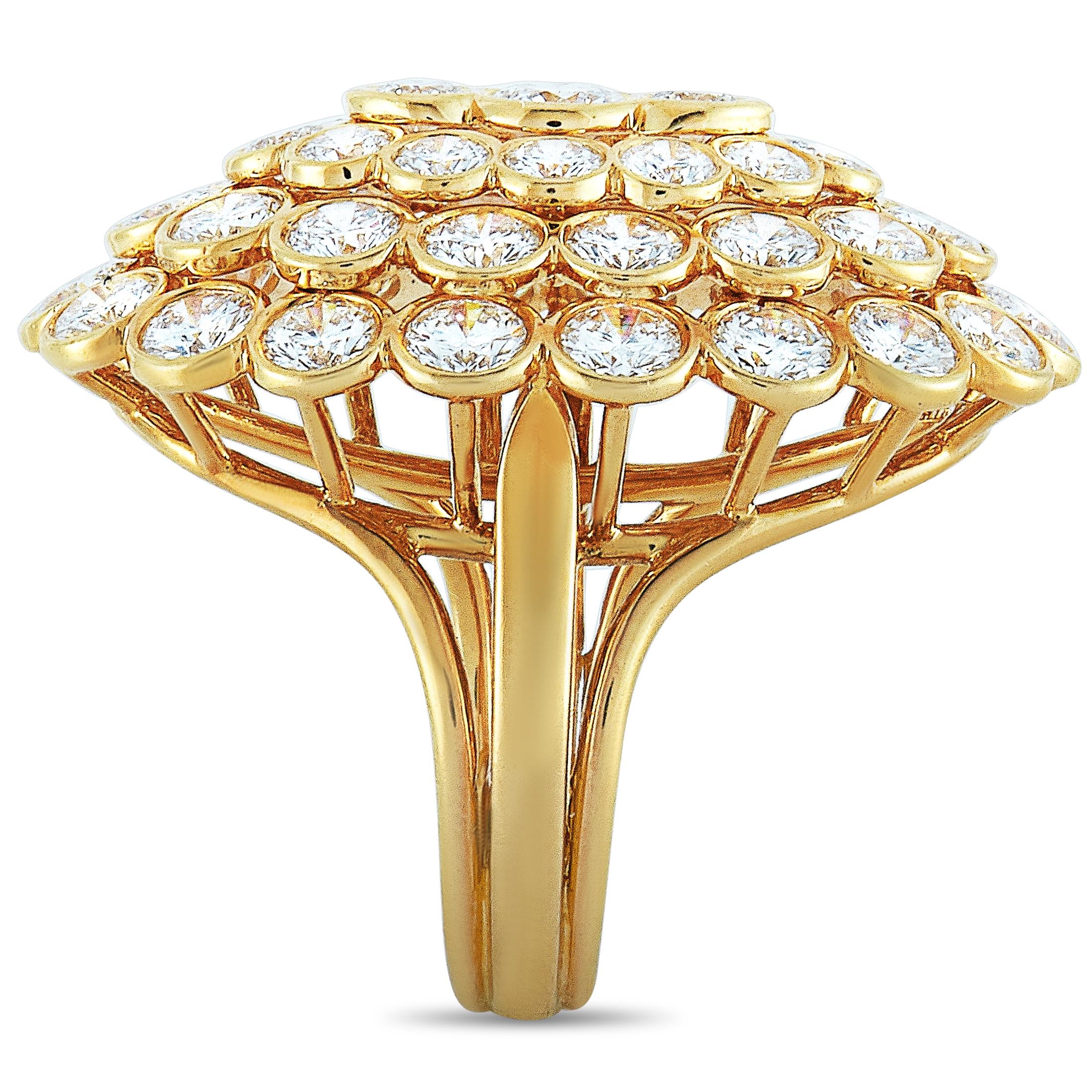 This Cartier ring is crafted from 18K yellow gold and weighs 11.1 grams, boasting band thickness of 4 mm and top height of 10 mm, while top dimensions measure 30 by 22 mm. The ring is embellished with diamonds that feature E-F color and VVS clarity