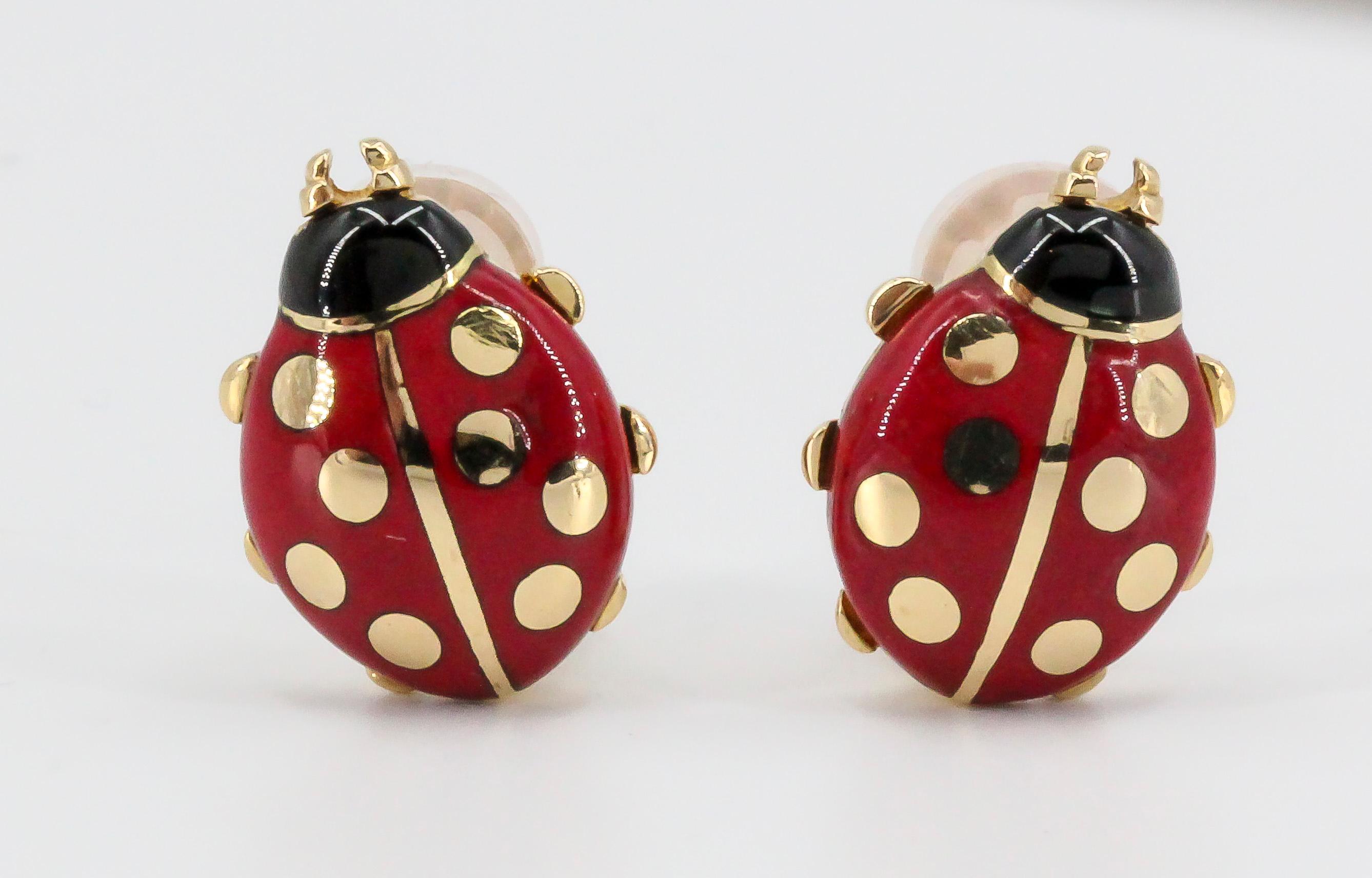 Whimsical 18K yellow gold and enamel earrings by Cartier. They resemble ladybugs, with red and black enamel over an 18K gold setting. 

Hallmarks: Cartier, reference numbers, 750, 1990, copyright.