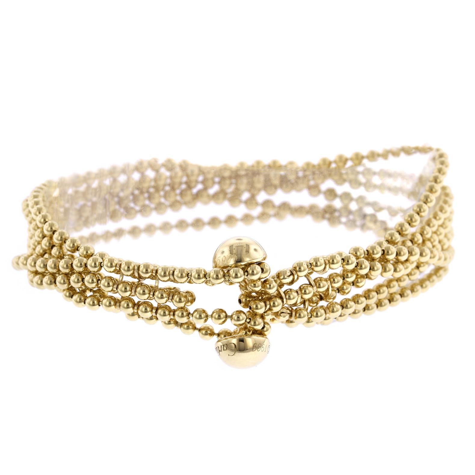Cartier 18K Yellow Gold Draperie Bracelet. The bracelet is designed with six
rows of gold bead chain completed by a button clasp, #I15973, length 6 1/4