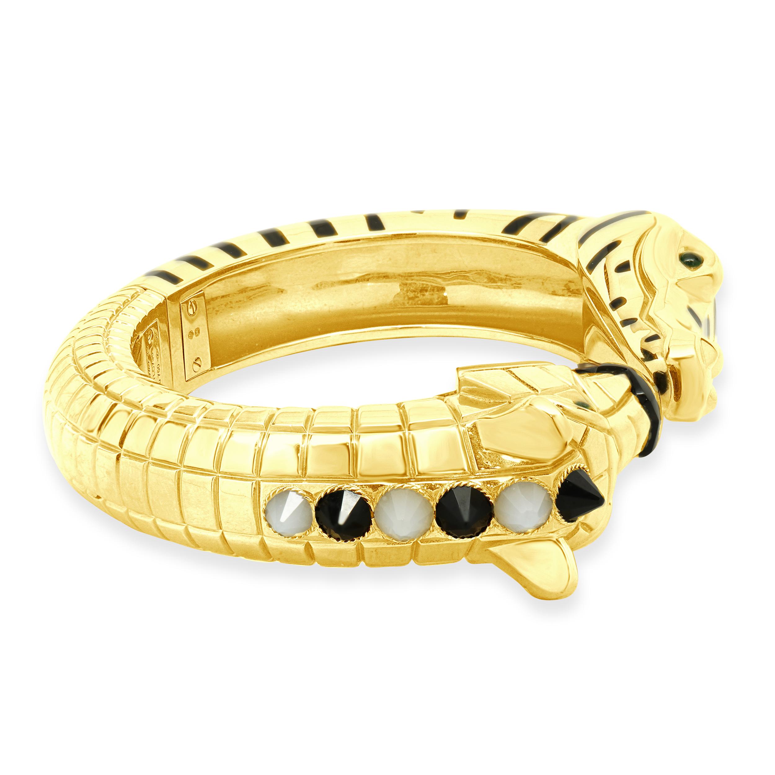 Designer: Cartier
Material: 18K yellow gold
Black Onyx, Tsavorite Garnet, Moonstone, and Black Lacquer
Serial # TLCXXX
Size 15

Complete with original box and papers