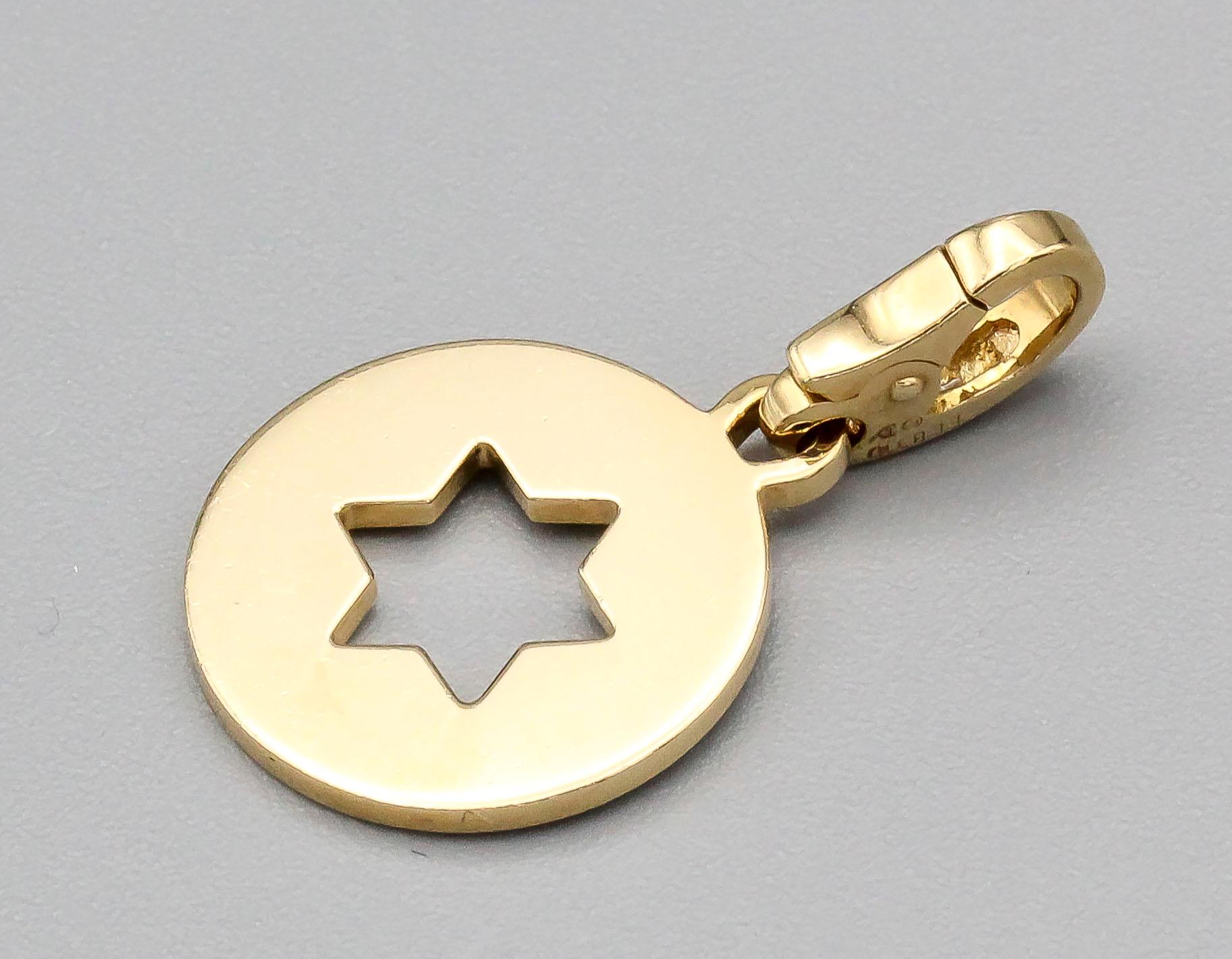 Fine 18k yellow gold Star of David charm by Cartier. 

Hallmarks: Cartier, 750, reference numbers.