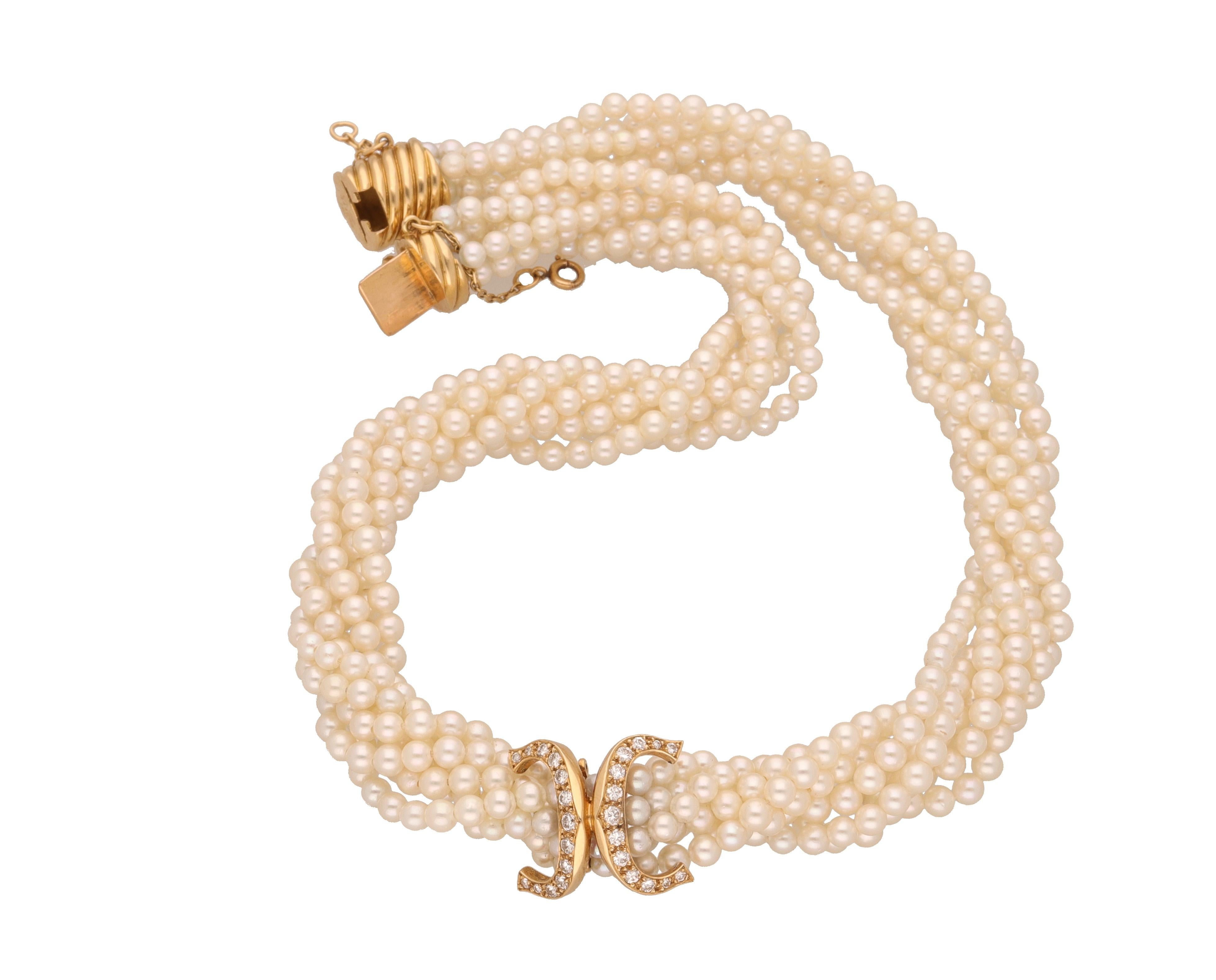 18 kt. gold multi-strand cultured seed pearls necklace.
The pearls are around 3.00 mm. in diameter, 7 strands.
In the middle of the necklace there is a double C setted with 1.00 carat ca. of round-cut diamonds.
Length included clasp is cm.