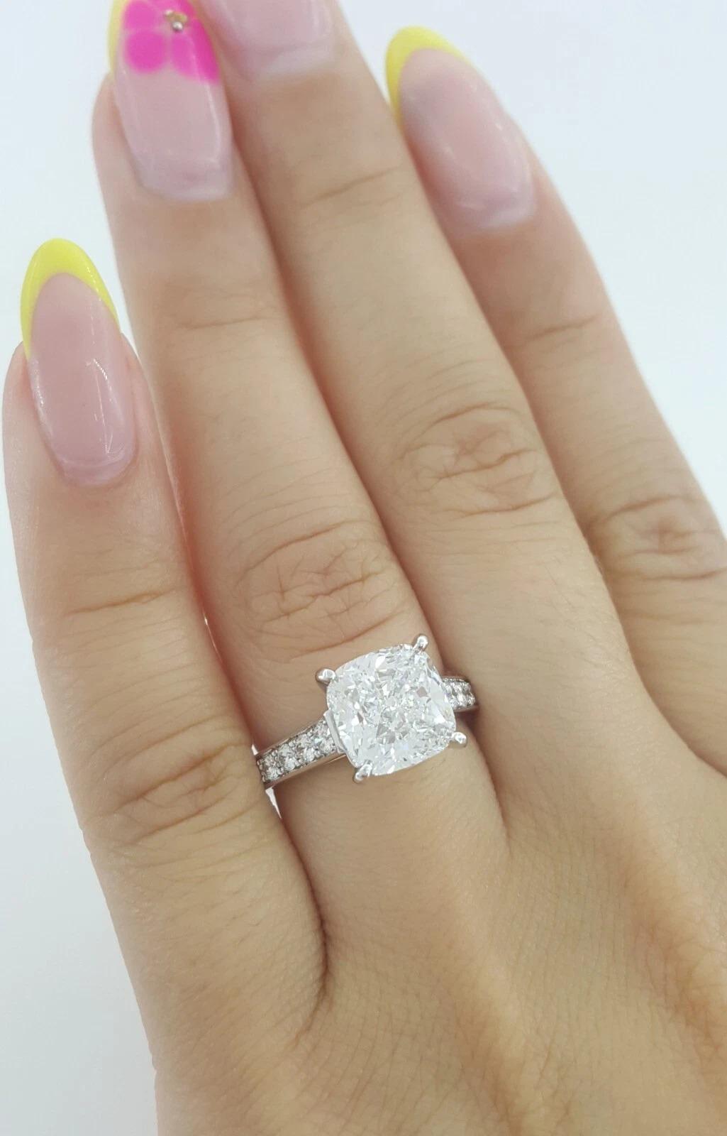 4.03 ct Cartier 1895 Cushion Cut Diamond Solitaire Pave Engagement Ring Rtl $150K

The ring weighs 6.2 grams, size 4.75 (French 49), the center stone is a 3.51 ct Natural Cushion Brilliant Cut diamond, F in color, VS2 in clarity, Excellent Polish,