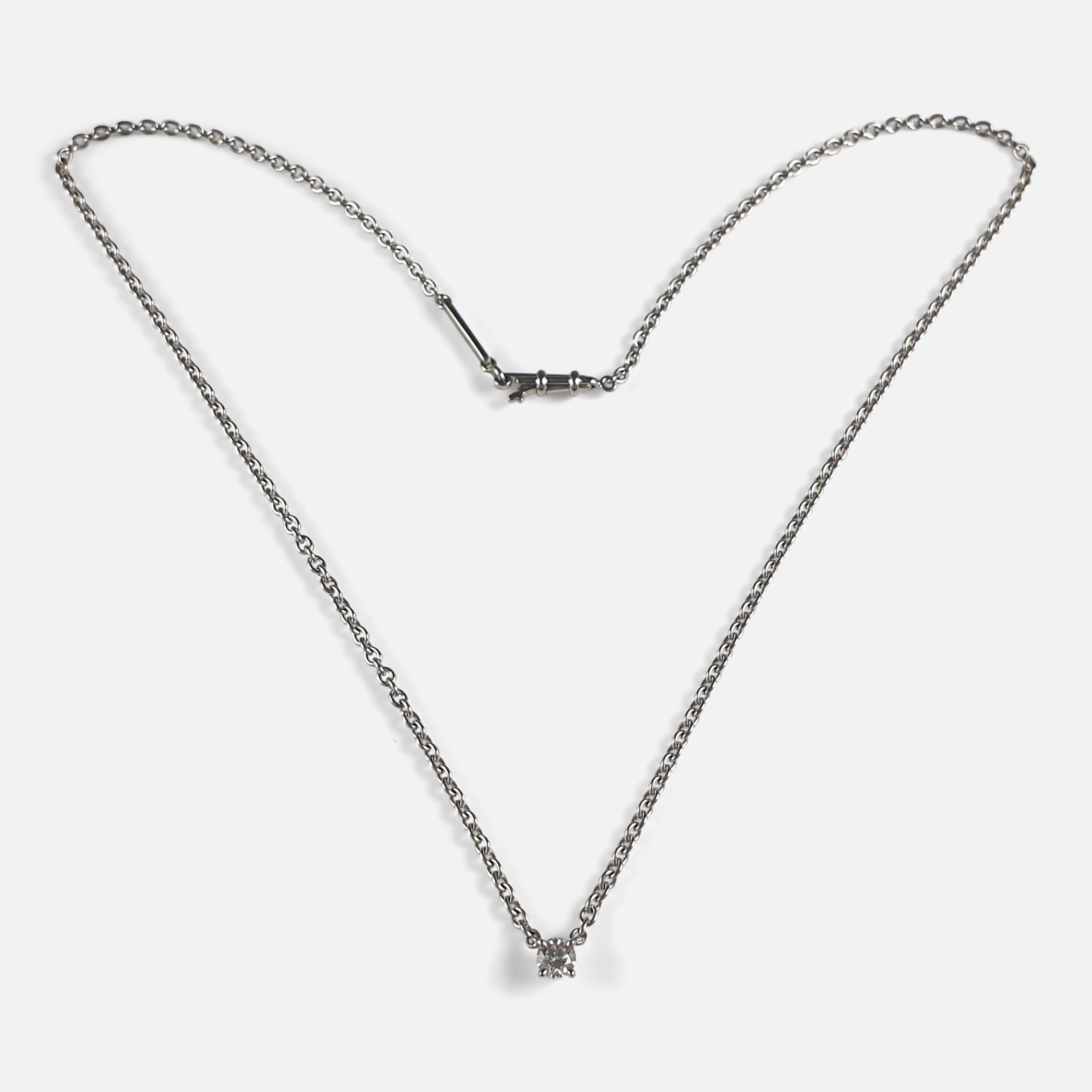 A Cartier 1895 Diamond Solitaire Necklace. This diamond solitaire necklace is a part of the '1895' collection by Cartier. The solitaire claw set round brilliant cut diamond weighs approximately 0.30 carat and is the central focus of the piece. The
