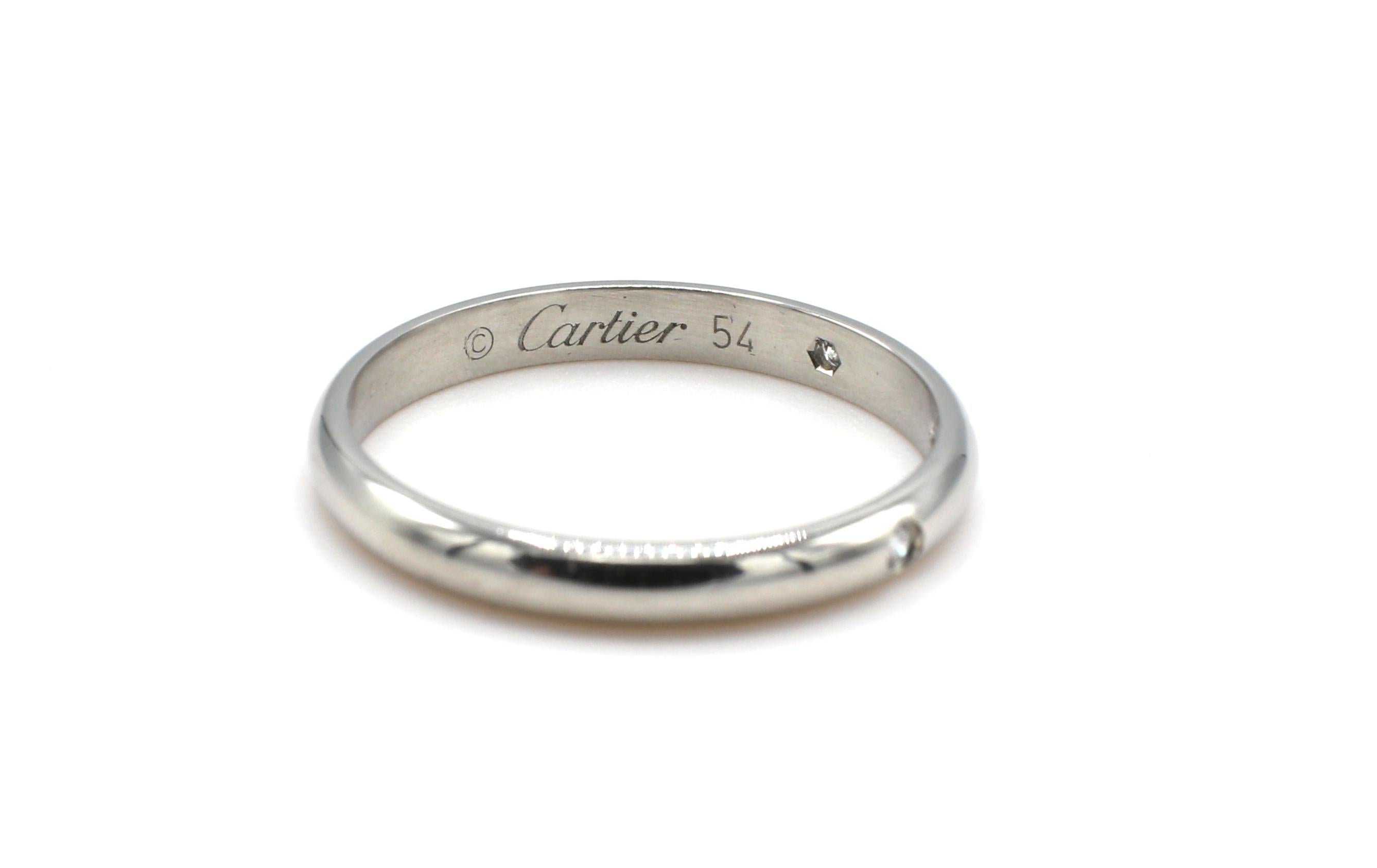 Cartier 1895 Platinum Diamond Wedding Band Ring 
Metal: Platinum 
Weight: 3.02 grams
Diamonds: 3 round brilliant cut diamonds, .03 CTW F-G VS
Width: 2.6MM
Signed: Cartier 54 HWF*** Pt950
Size: 54 (6.75 US)
Box & papers 
Retail: $1,650 USD

