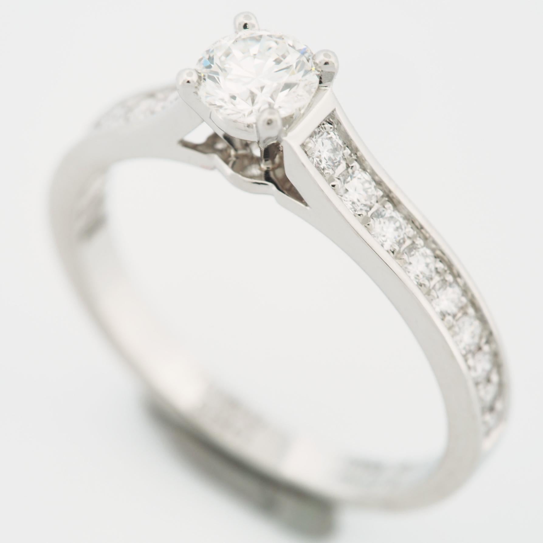 Item: Authentic Cartier 1895 Diamond Solitaire Ring
Stones: Diamond ( center stone 0.30 ct ) with 18 pave diamonds
Color: H
Clarity: VVS2
Polish: Excellent 
Symmetry: Excellent
Fluorescence: None
Metal: Platinum 950
Ring Size: 49 US SIZE 4.75 - 5.0