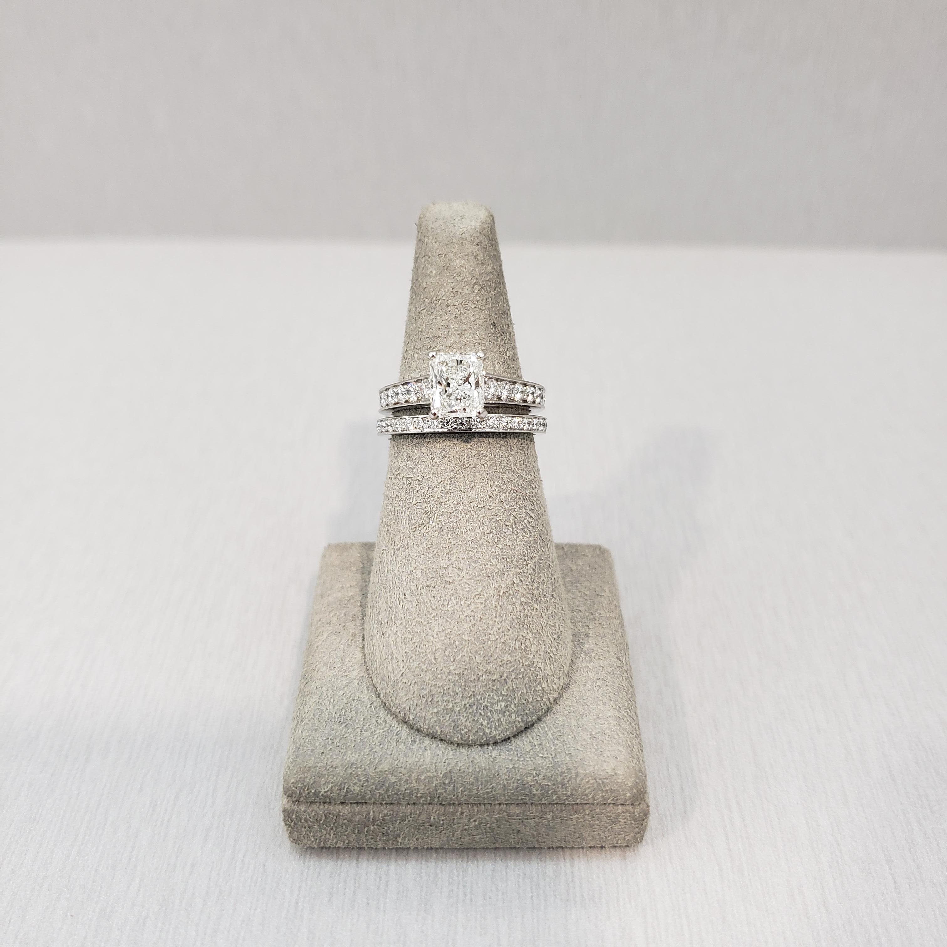 A radiant cut engagement ring made, signed and numbered by Cartier. Part of the 1895 Collection of Cartier. Set with a 1.03 carat radiant cut diamond center stone that GIA certified as G color VVS1 clarity. 22 round brilliant diamonds weighing 0.60