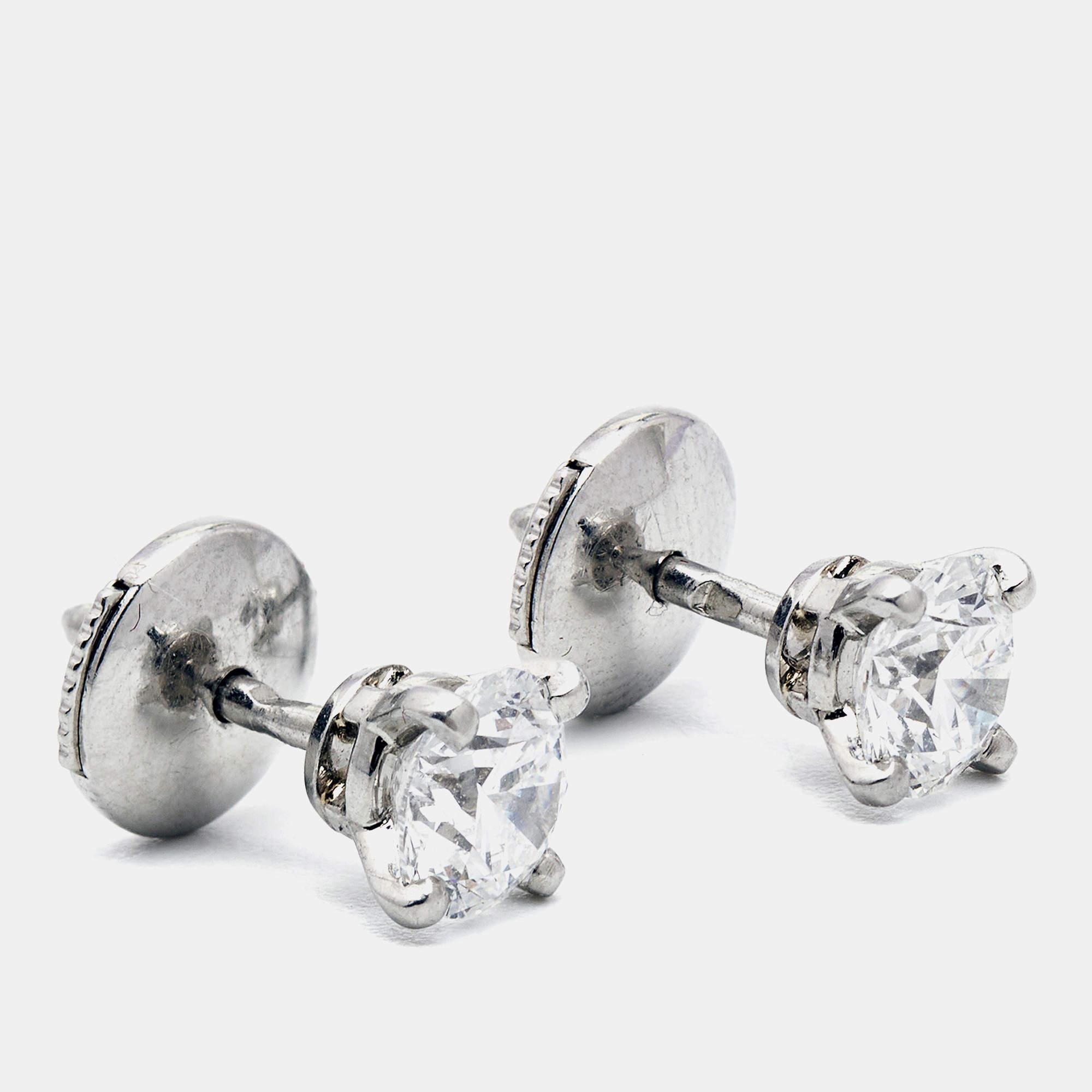 Indulge in timeless elegance with Cartier's 1895 earrings. Crafted with exquisite precision, each earring boasts a brilliant round-cut diamond cradled in lustrous platinum settings, radiating sophistication and grace. Elevate any ensemble with these
