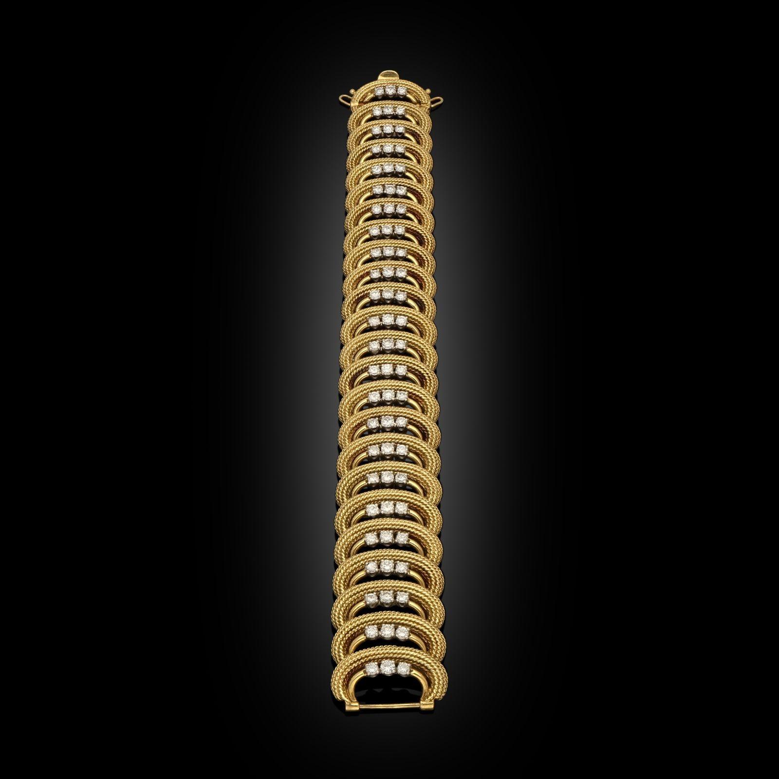 A beautiful 18ct gold and diamond bracelet by Cartier c.1950s, the wide straight bracelet formed of twenty-four C shape motifs in 18ct yellow gold with rope twist detailing, each with a round gold wire following the inside curve which is set with