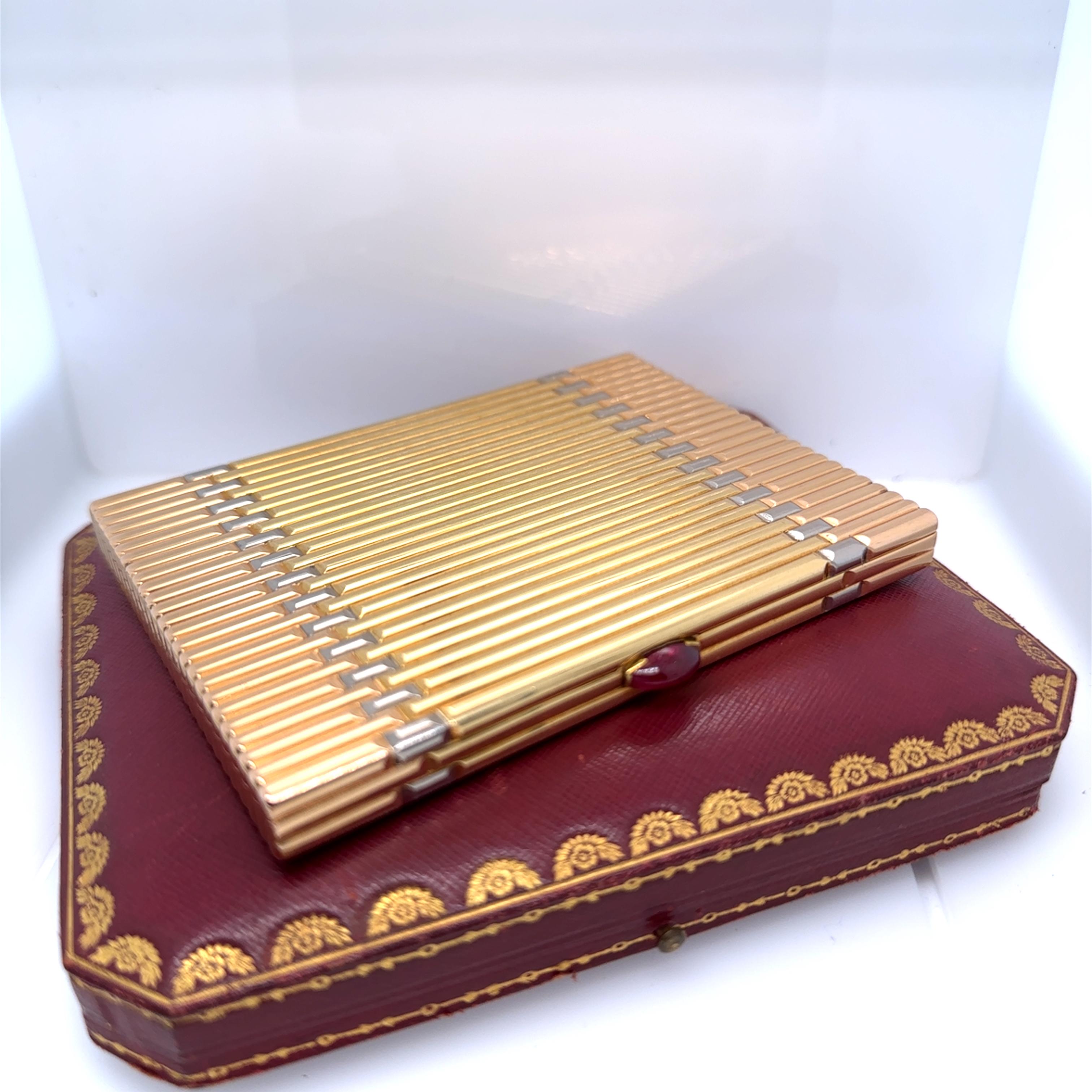 A Vintage Cartier Cigarette case, made in 1937. The rectangular fluted case is in yellow, rose and white 18ct gold Weighing 245.18g. The case clasp is set with an oval, Cabochon cut Ruby. The Ruby measures 11 mm x 5.3mm x 4mm. 

Metal: 18ct Yellow,