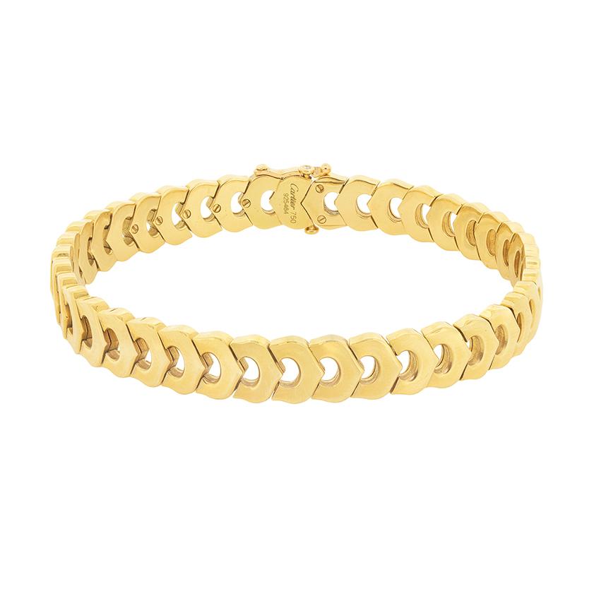 Classically Cartier, this bracelet wraps your wrist in 18 carat gold 