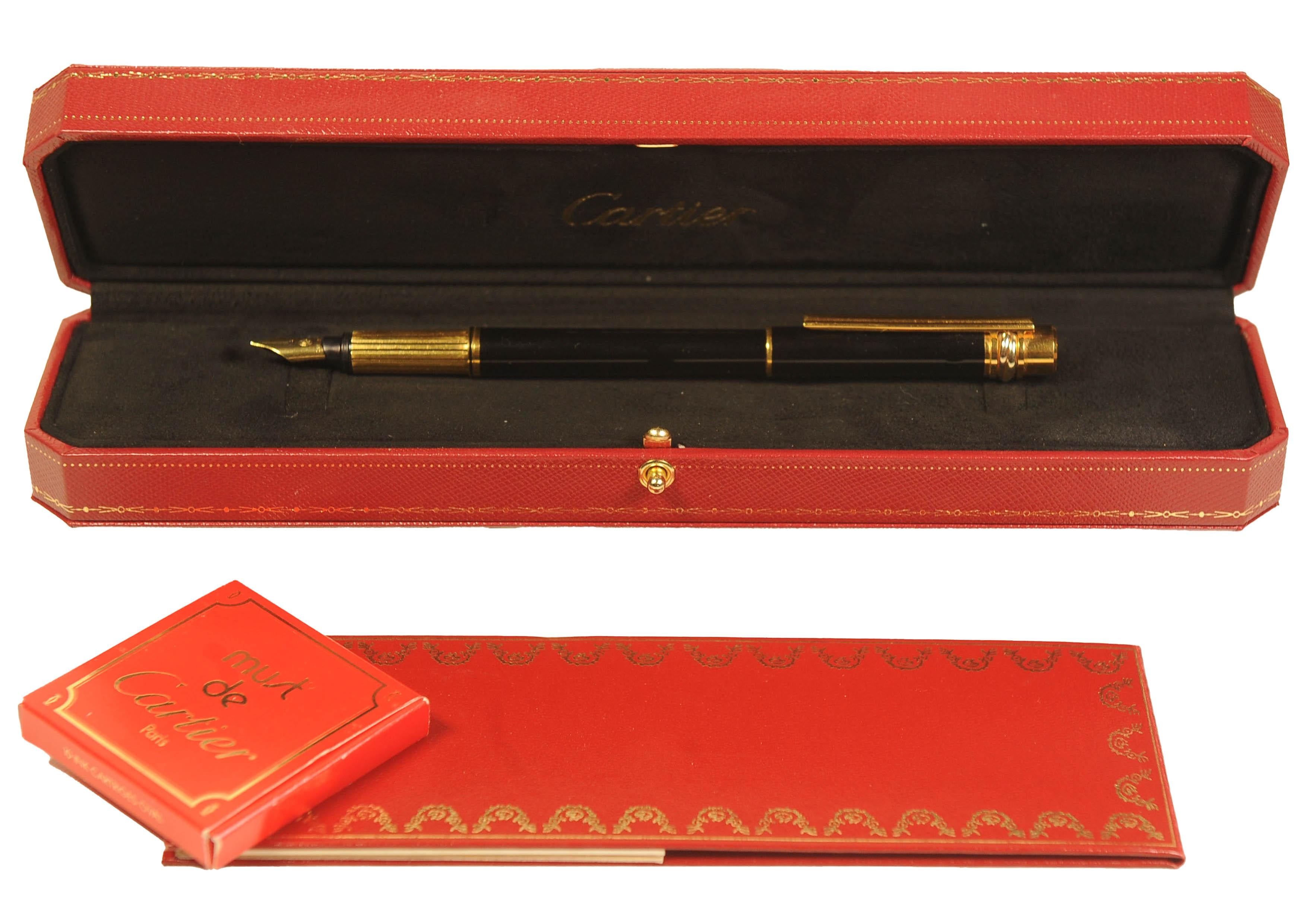 Beautiful Sleek Cartier 18K Gold Nib Black Body Trinity Fountain Pen With Box 
Designed by Cartier and Manufactured by MontBlanc

The pen is made from a black composite
Pen nib is 18K Yellow Gold Stamped 750     
Pen Serial Ref  969414
Made in