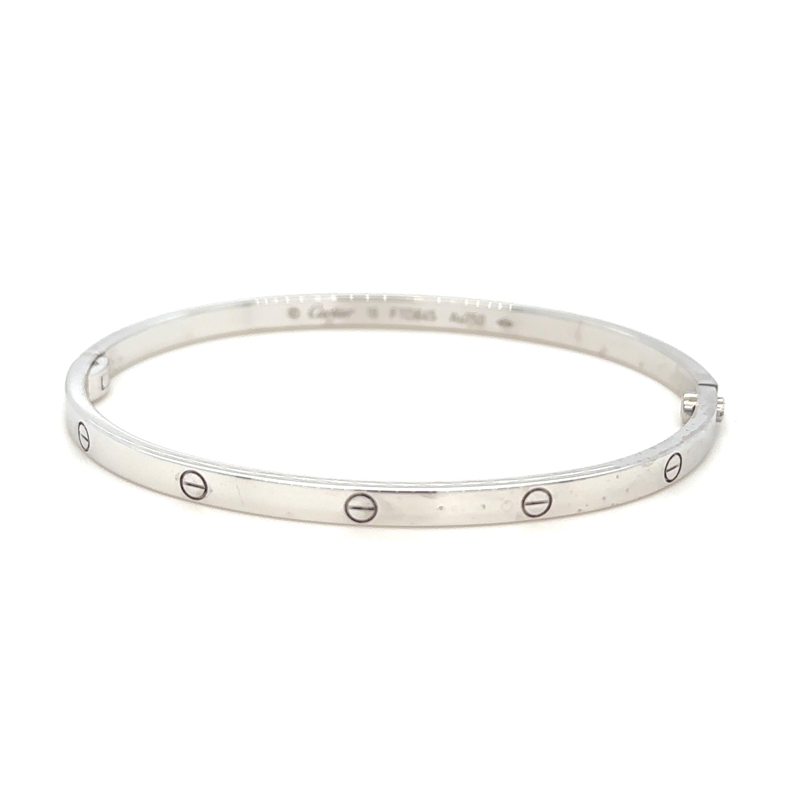 A Cartier 18ct White Gold Love Bangle.

Width 3.7mm. Size 18. FTD845.

Weight 21.09 grams.

Cartier REF: B6047417, with screw driver.

Metal: 18ct White Gold
Carat: N/A
Colour: N/A
Clarity:  N/A
Cut: N/A
Weight: 21.09 grams

Engravings/Markings: