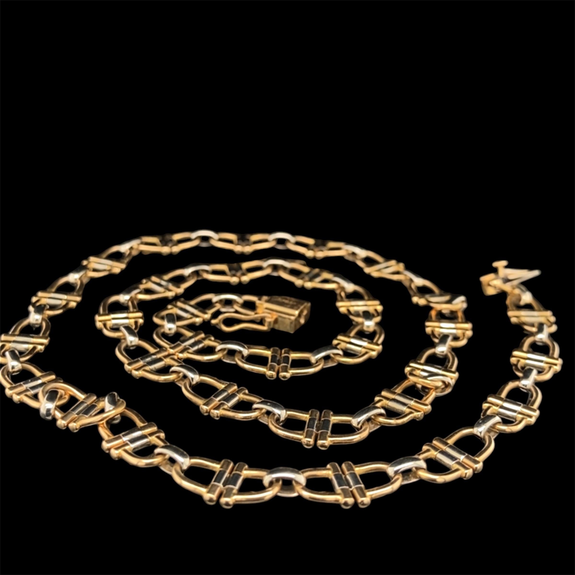 A fine bicolour 18K gold equestrian theme necklace by Cartier, 1970s

Each element of the necklace of stir-up shape in white and yellow 18K gold, with a yellow gold 18K padlock clasp;

signed Cartier, numbered 738226, marked 750.
